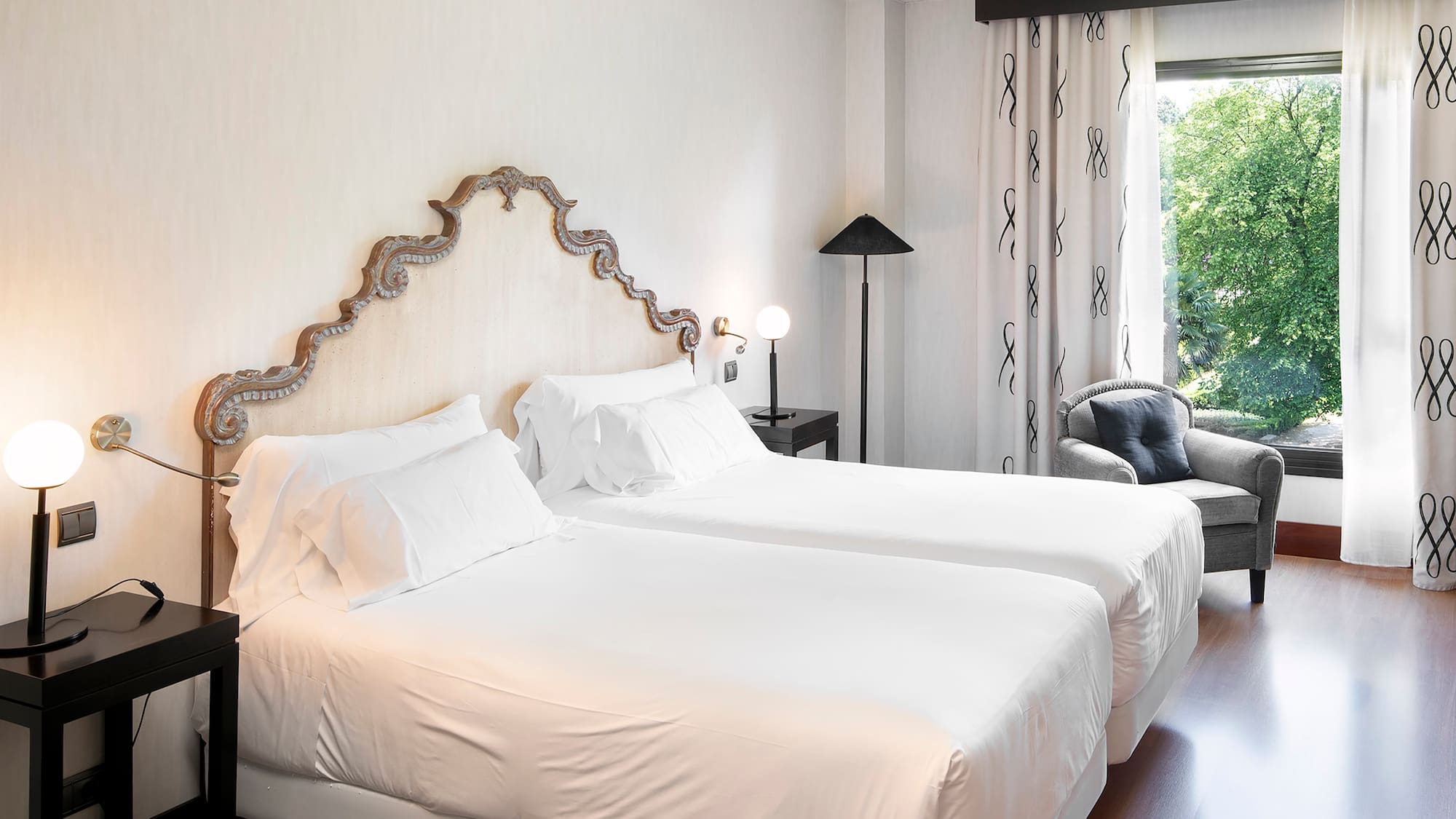 a room with two beds and a chair