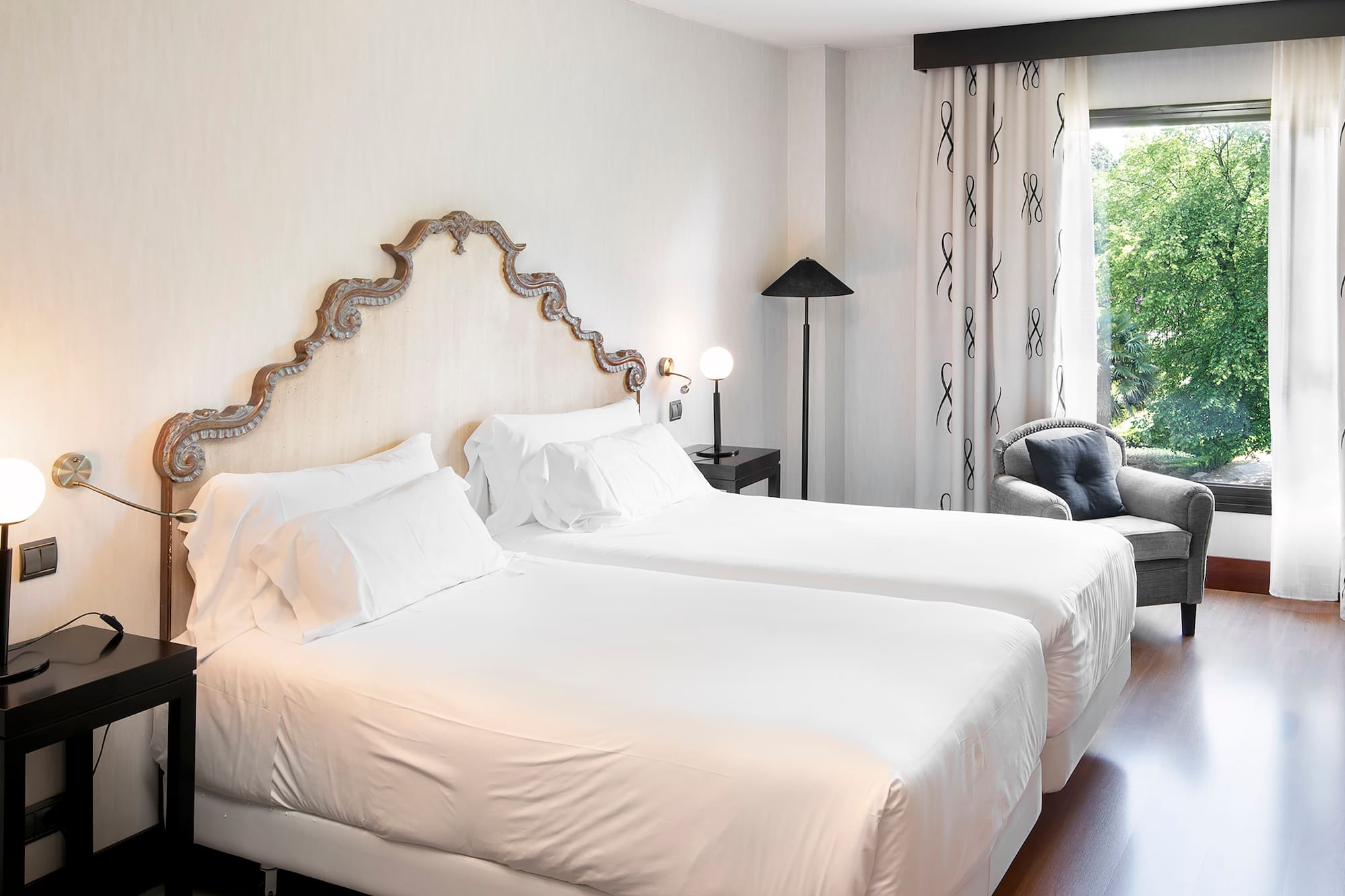 a room with two beds and a chair