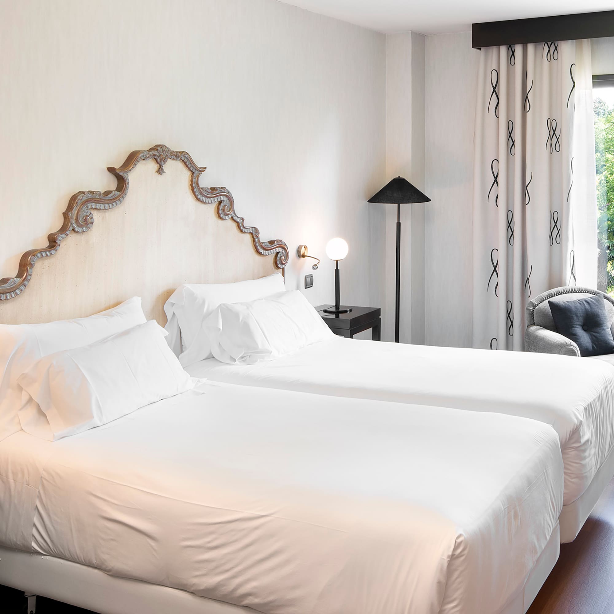 a room with two beds and a chair