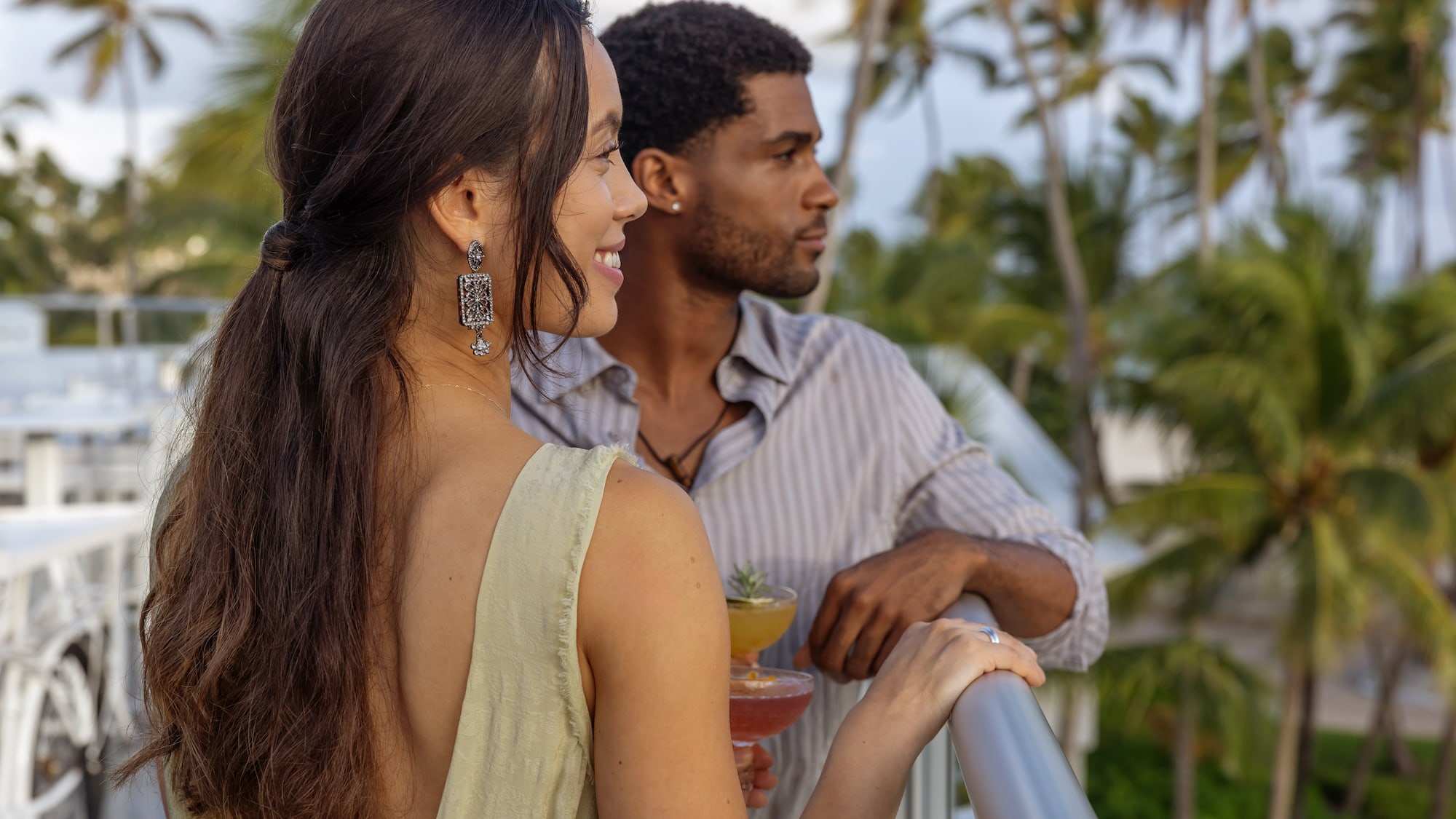 a man and woman standing on a balcony