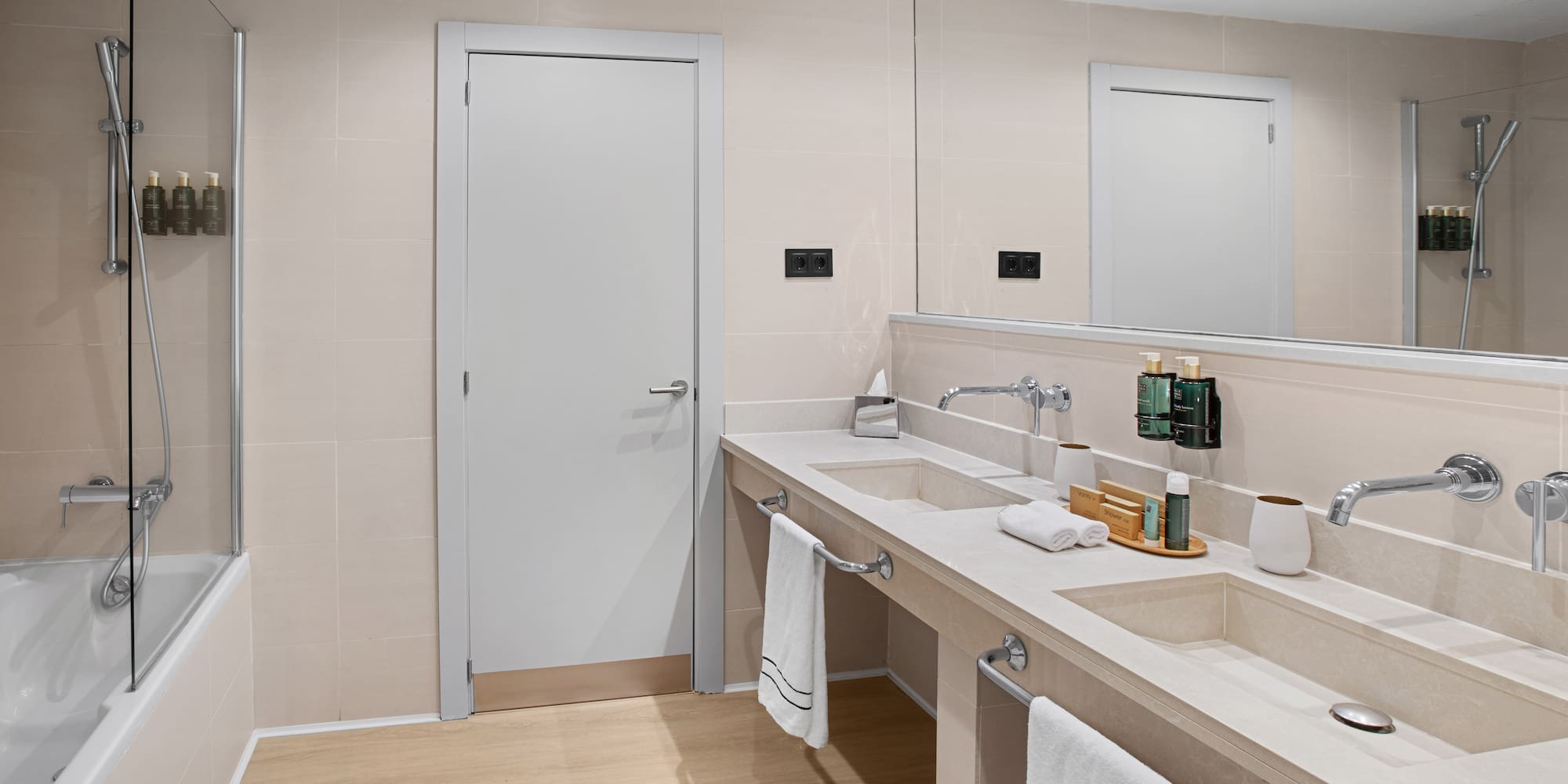 a bathroom with a double sink and a door