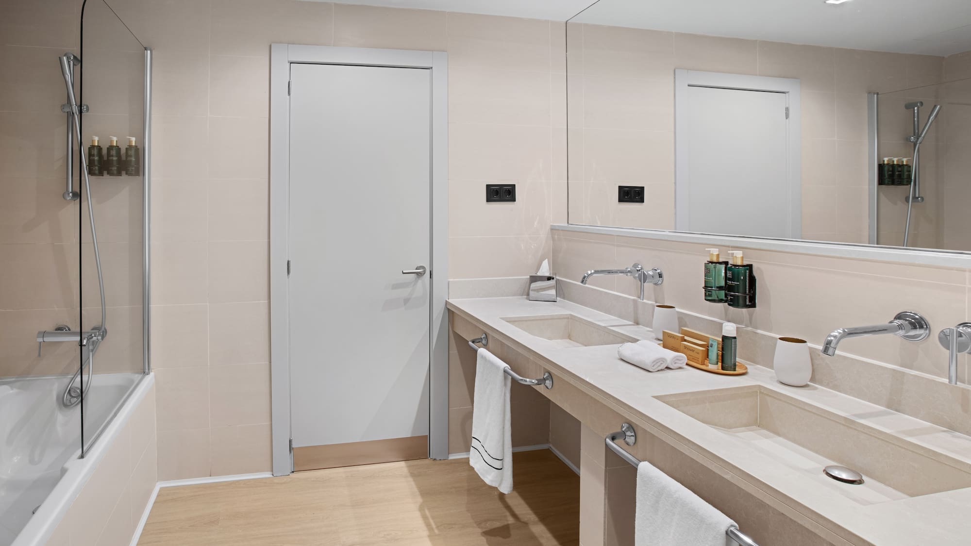 a bathroom with a double sink and a door