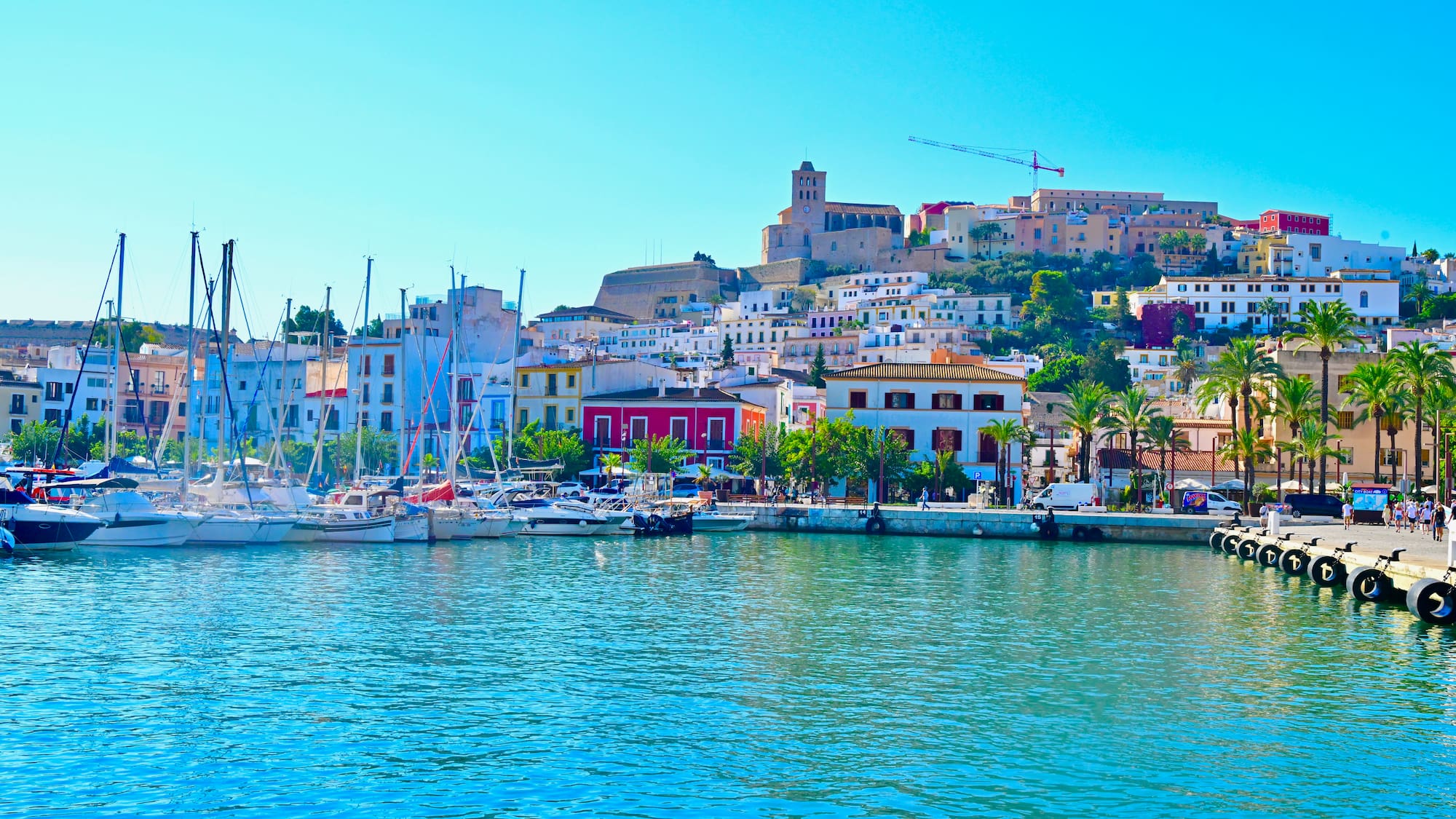 a body of water with boats and buildings on the side