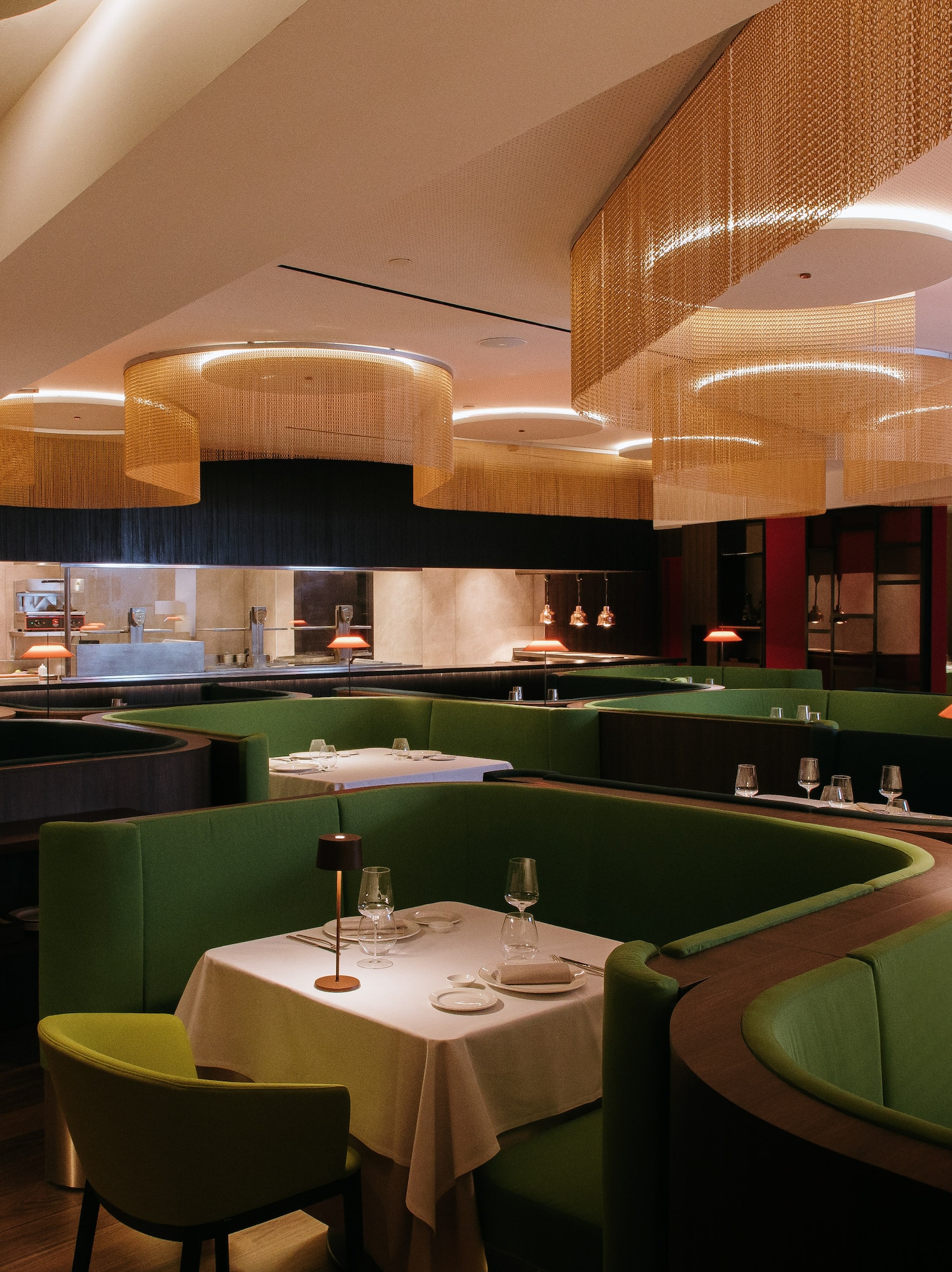 a restaurant with green couches and tables