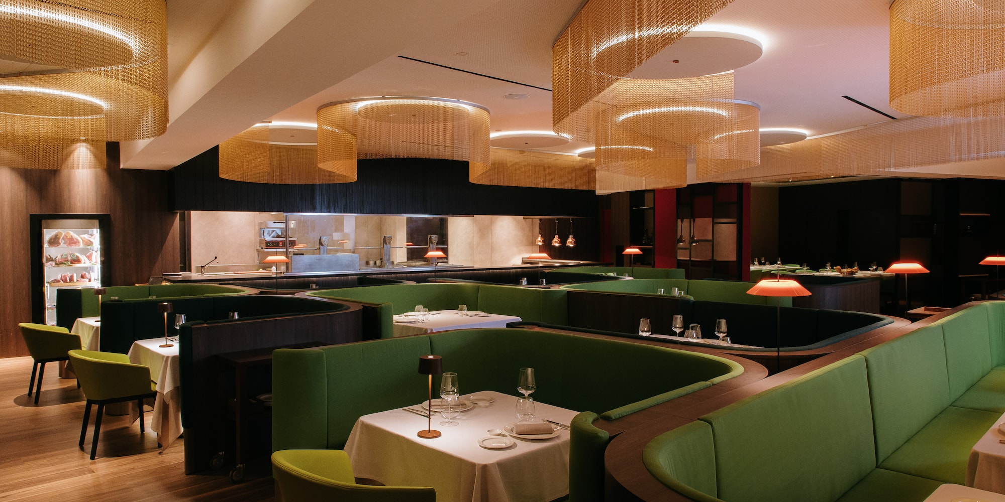 a restaurant with green couches and tables