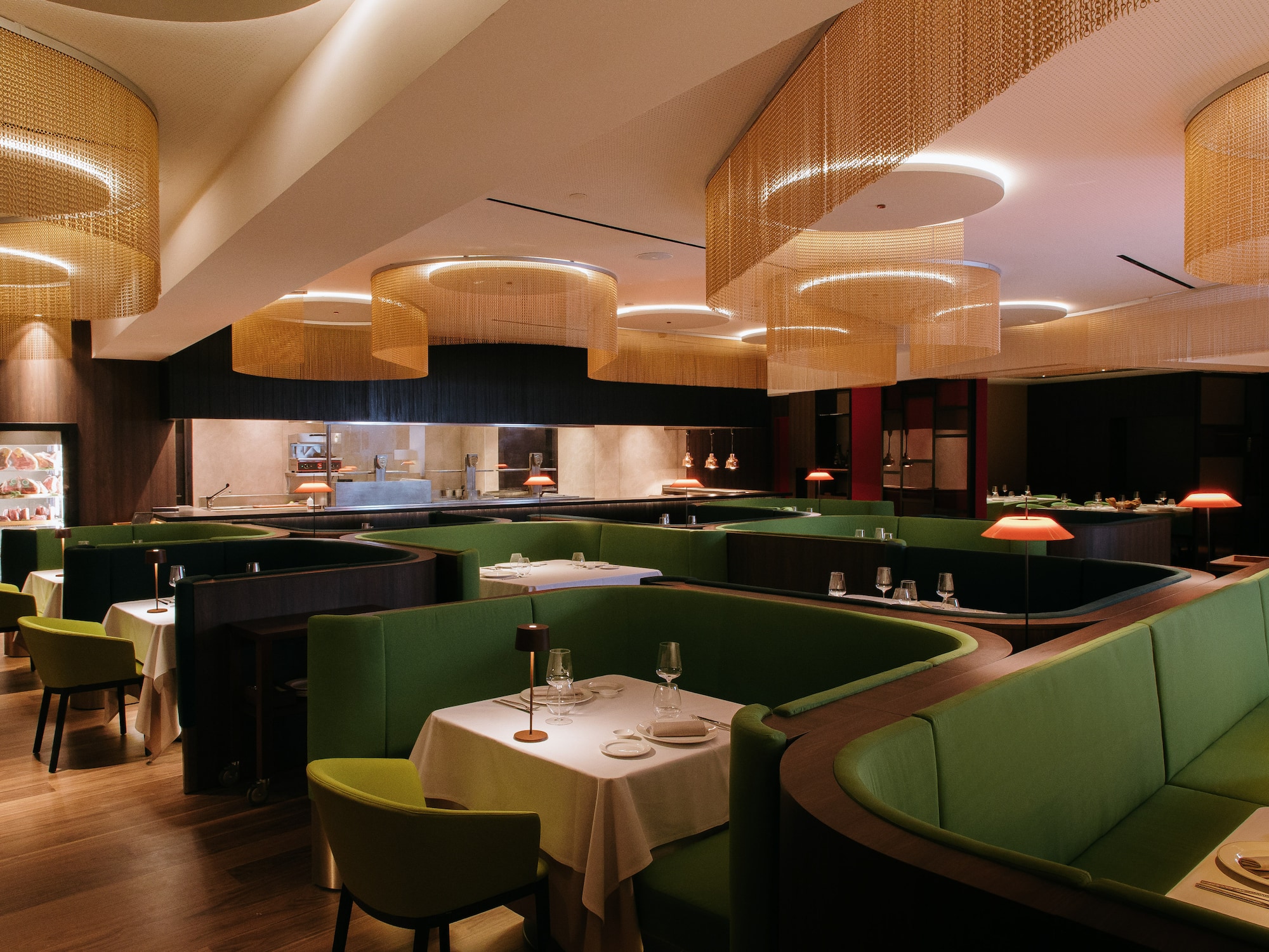 a restaurant with green couches and tables