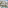 Tropical resort with white buildings, lush palm trees, swimming pools, and ocean.