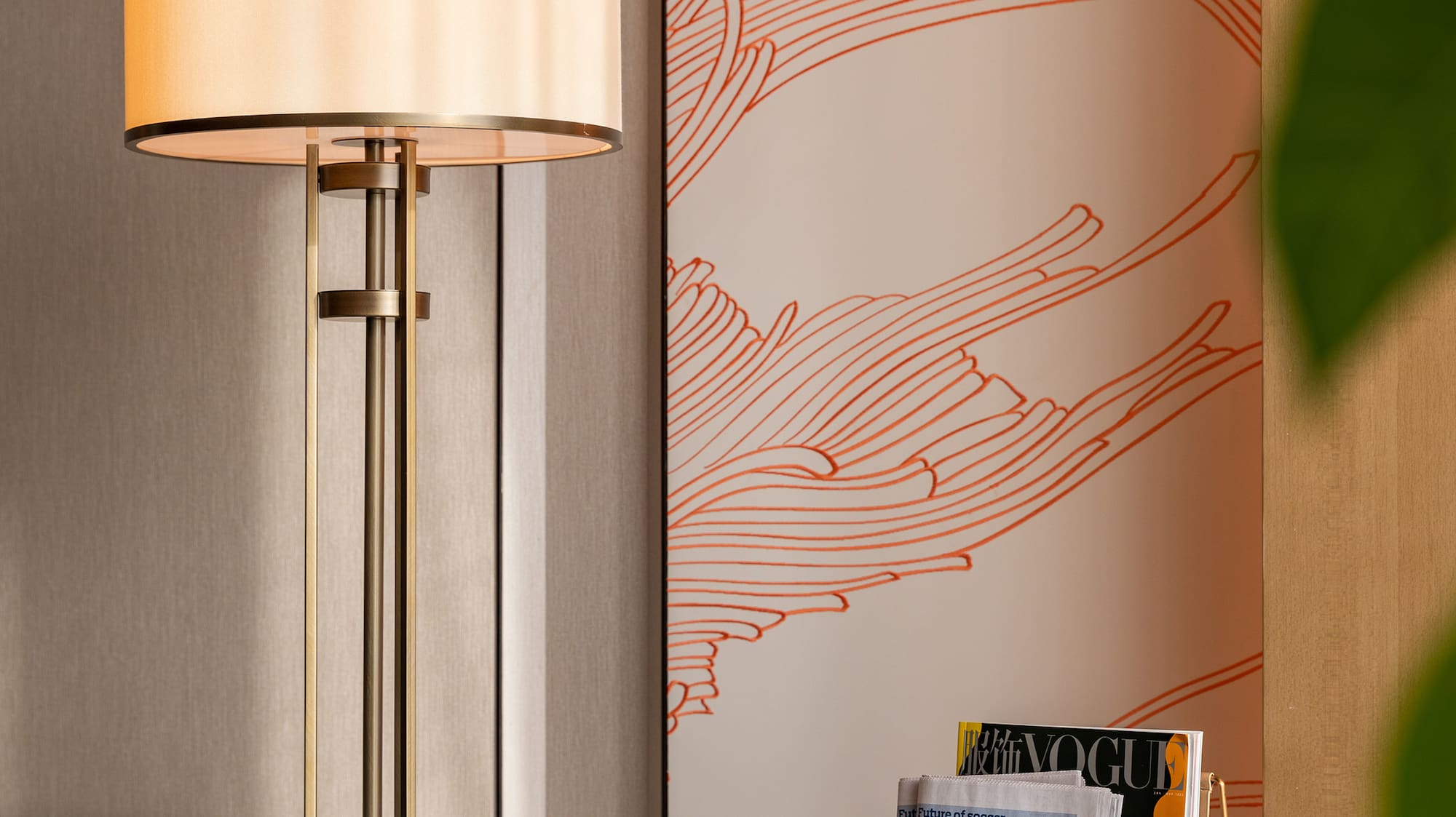 a lamp next to a magazine rack