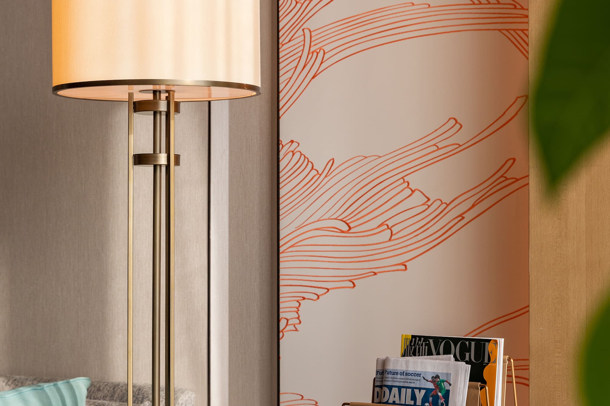 a lamp next to a magazine rack