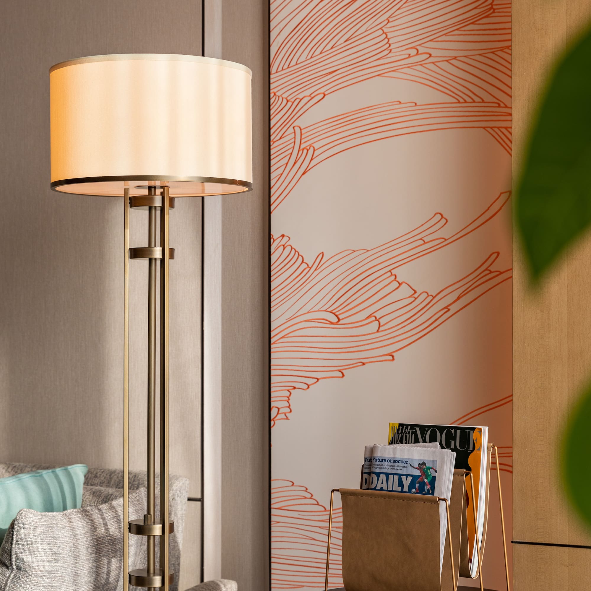 a lamp next to a magazine rack