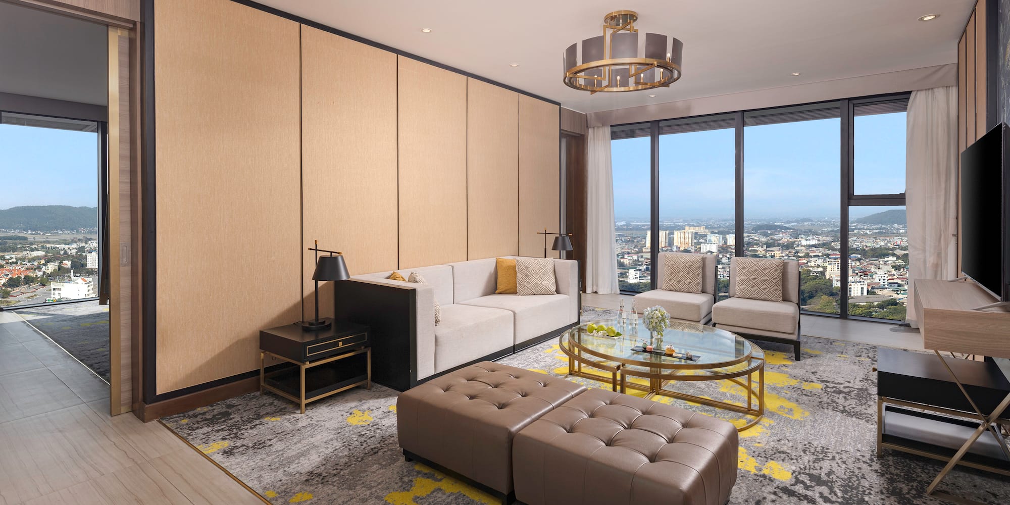 a living room with a large window and a city view