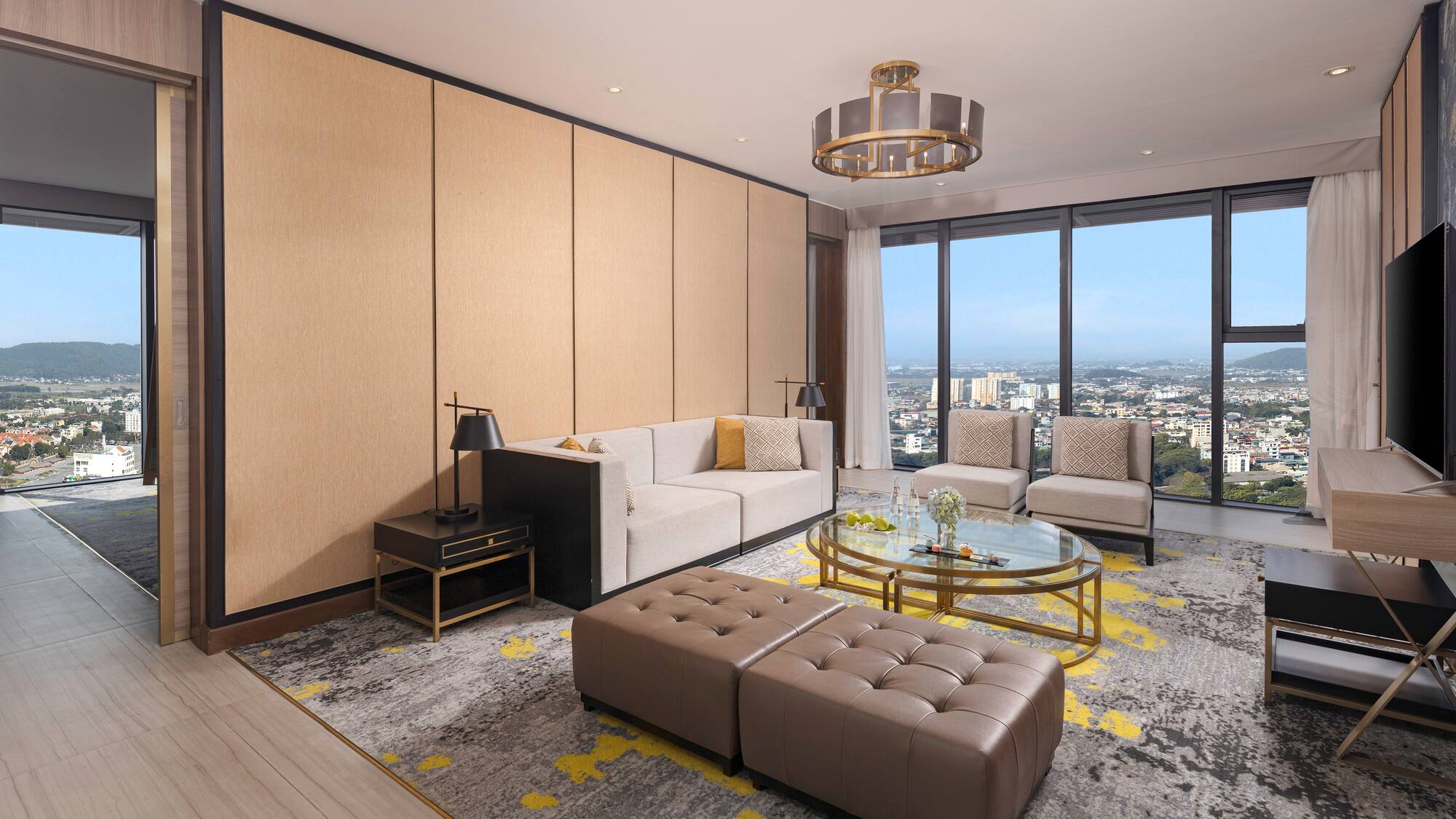 a living room with a large window and a city view