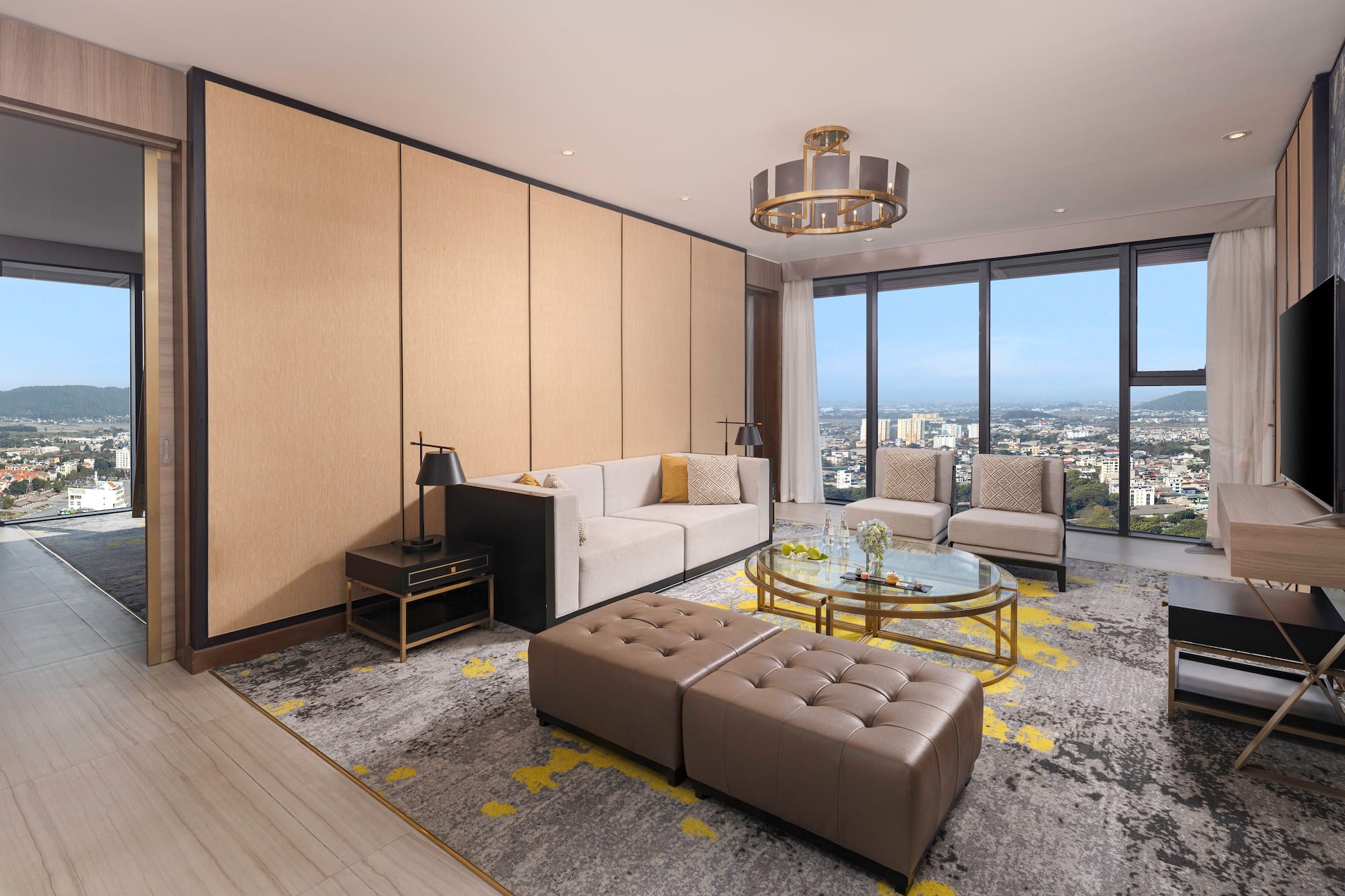 a living room with a large window and a city view