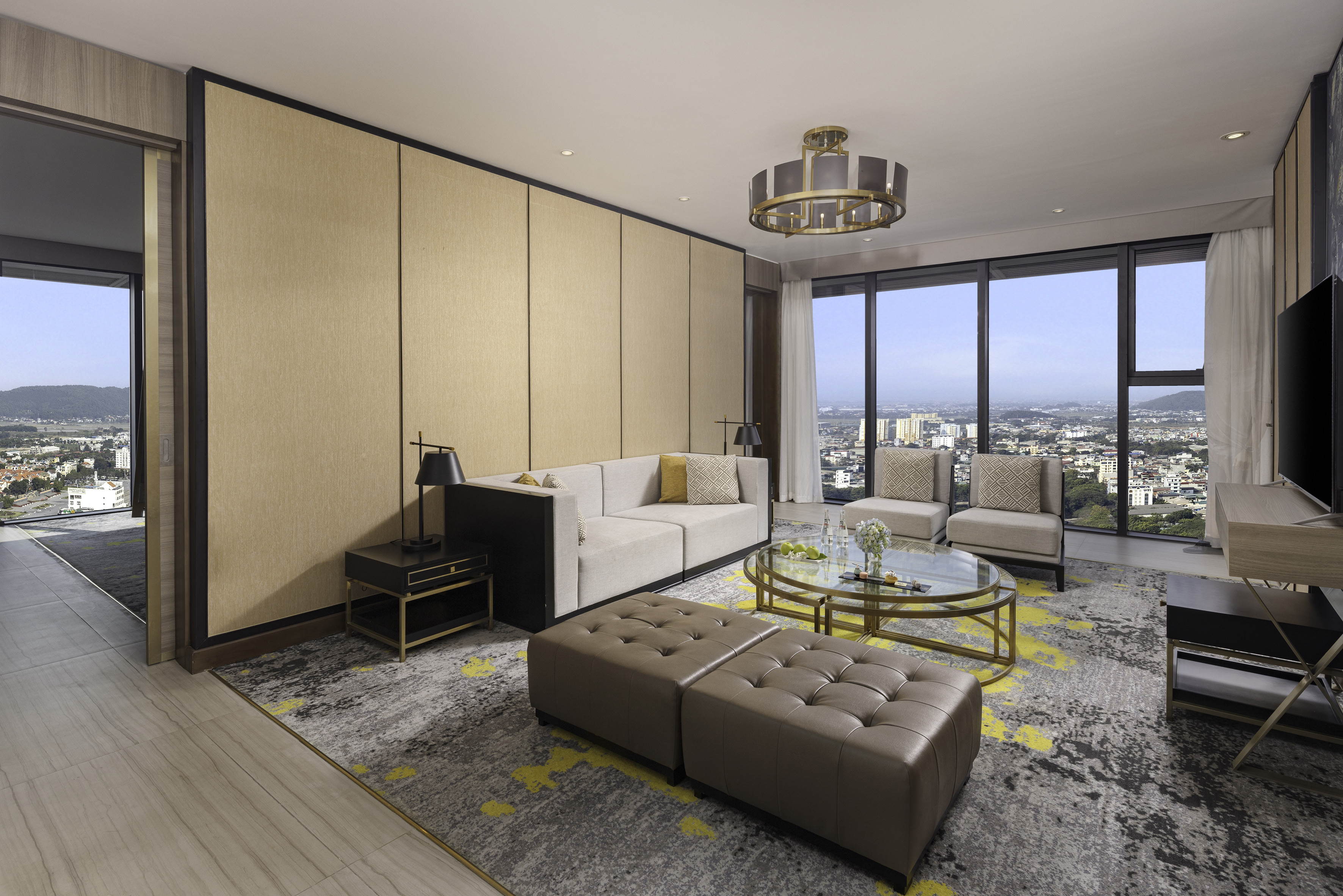 a living room with a large window and a city view