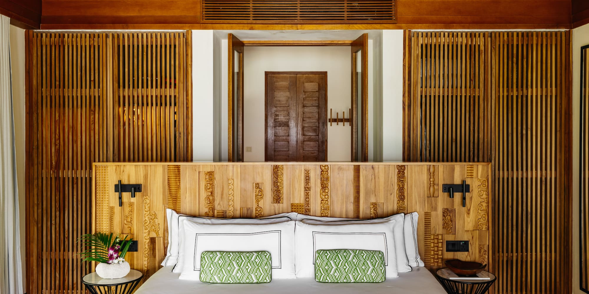 a bed with a wood headboard
