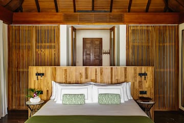 a bed with a wood headboard