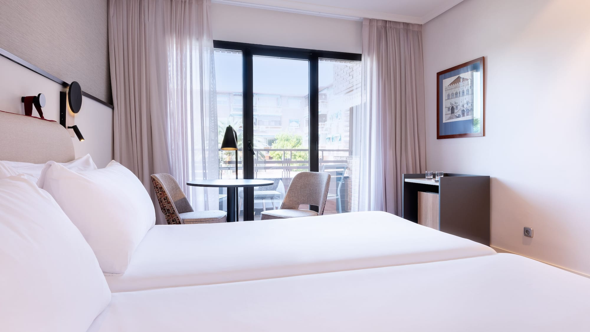 a room with two beds and a table