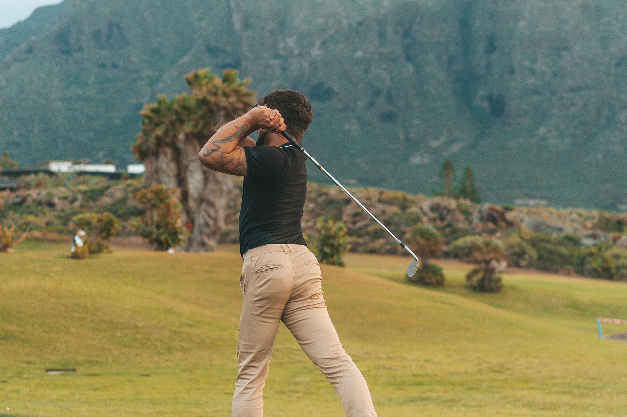 a man swinging a golf club