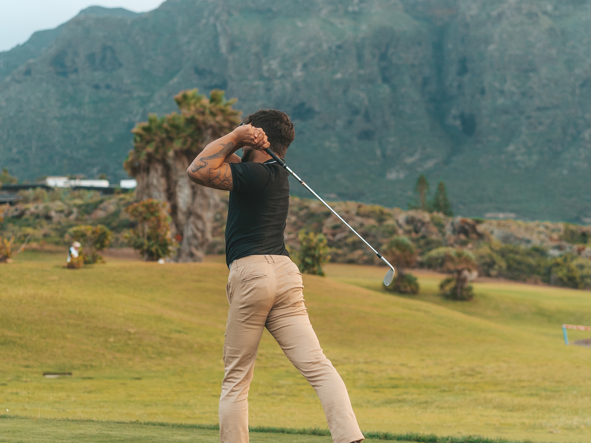 a man swinging a golf club