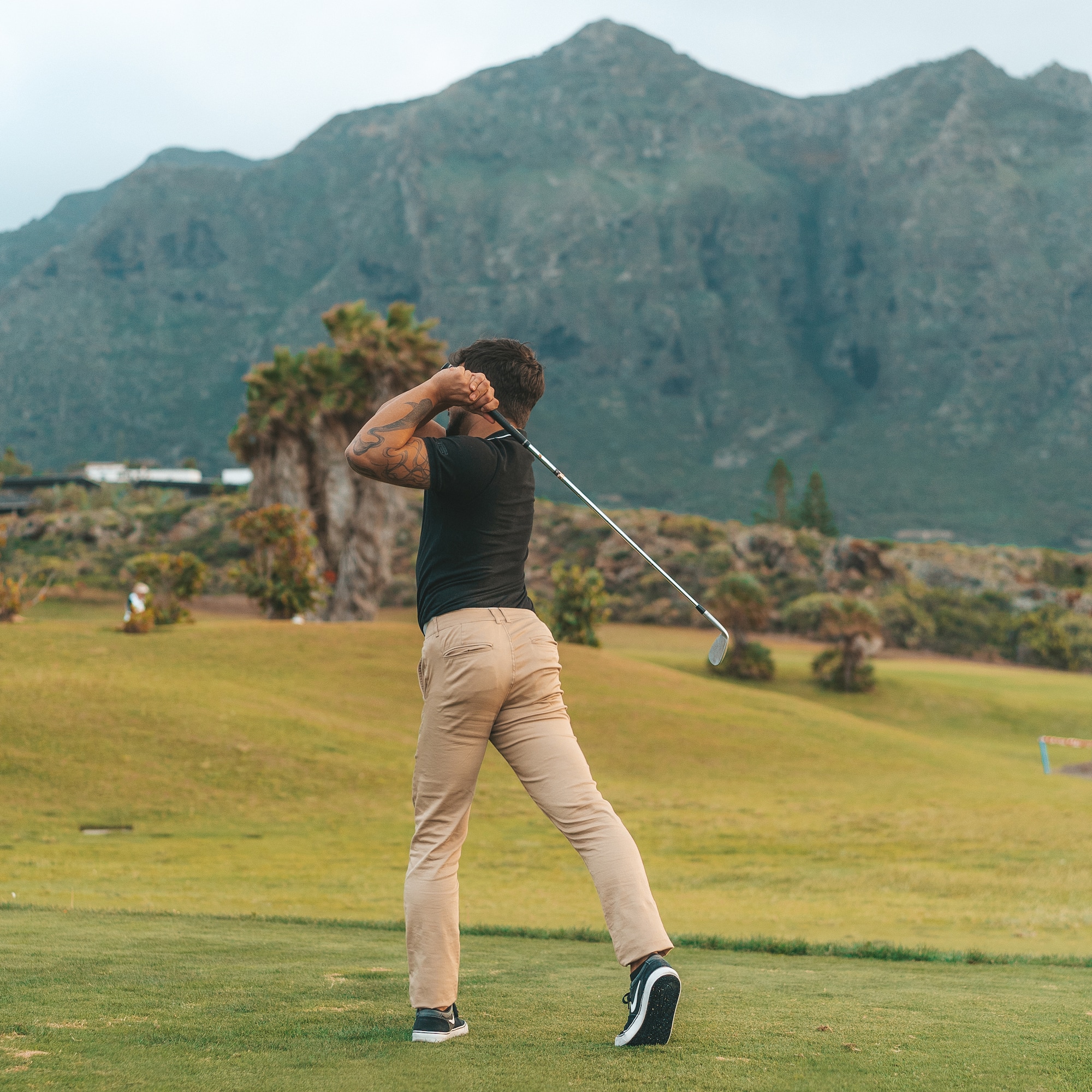 a man swinging a golf club