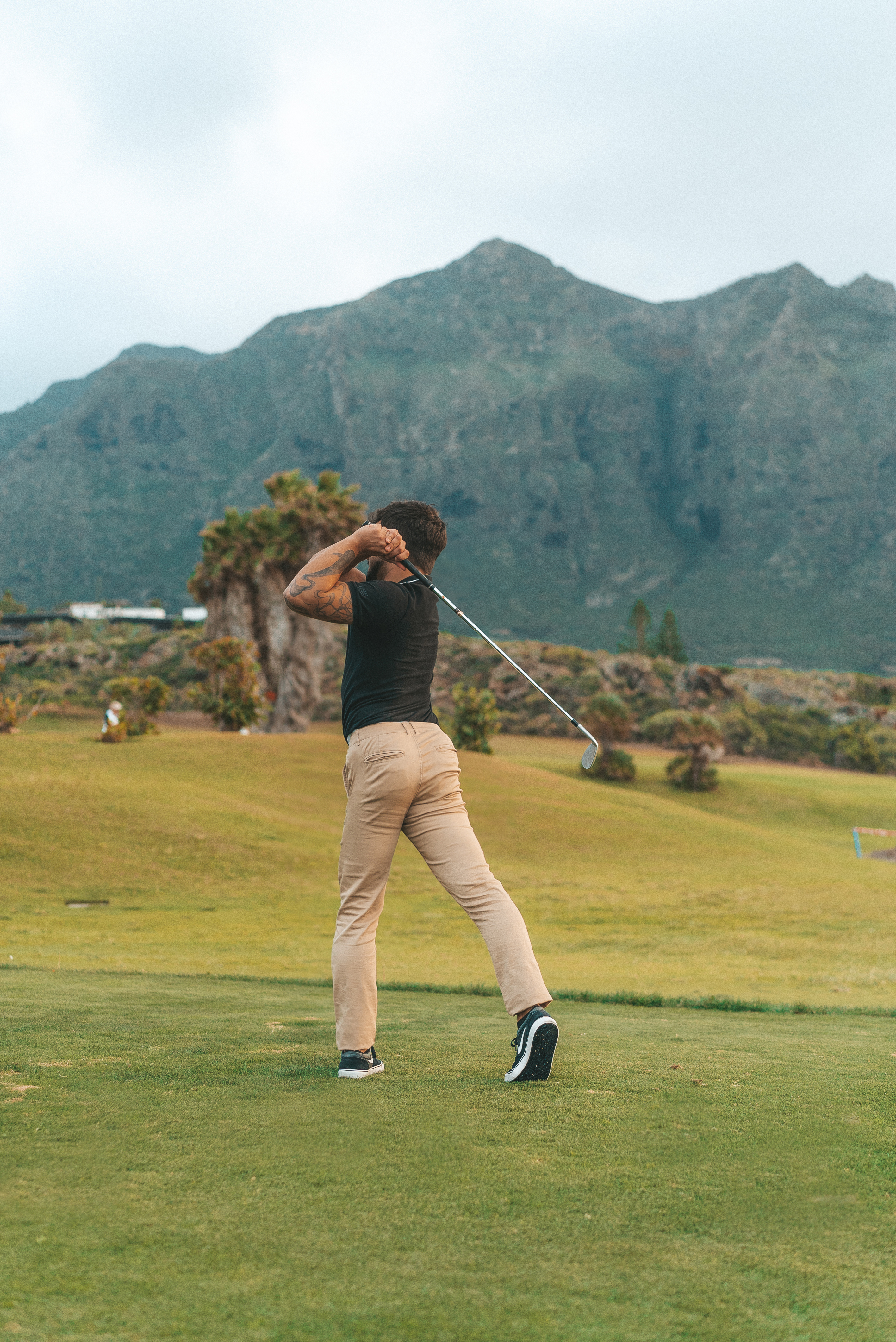 a man swinging a golf club