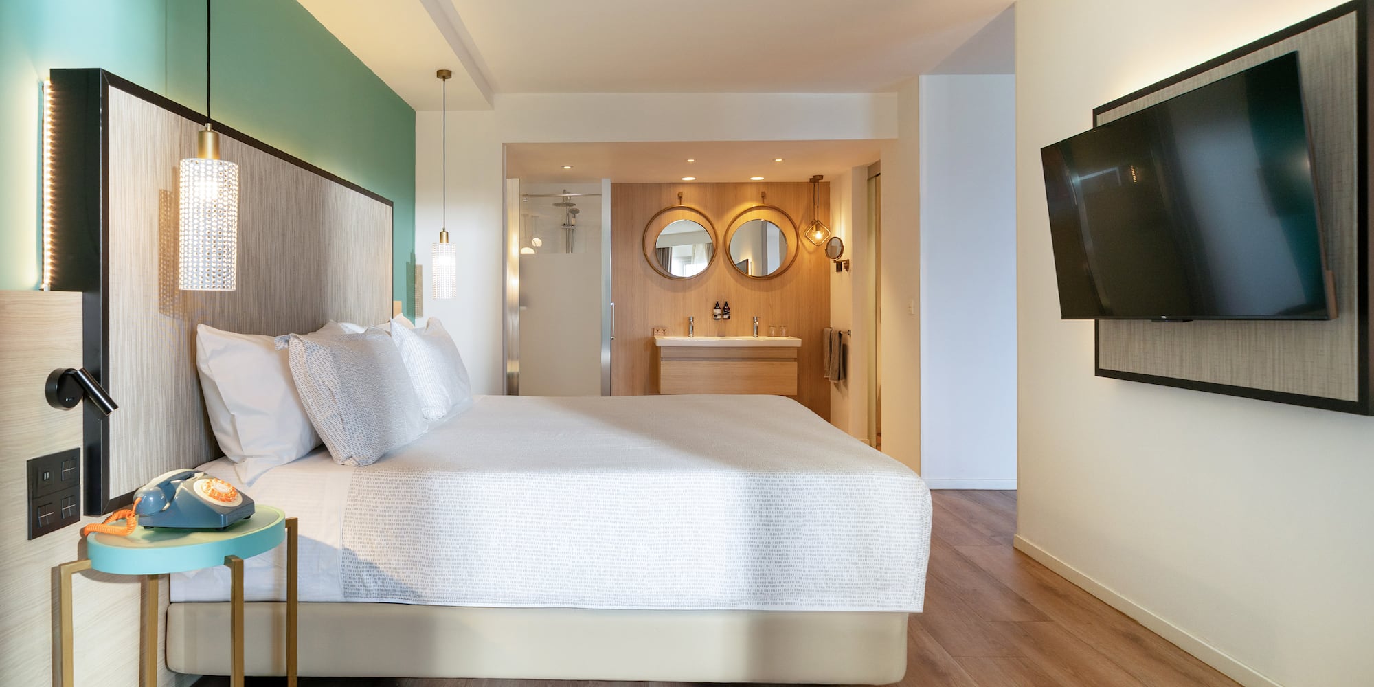 a bedroom with a large bed and a television