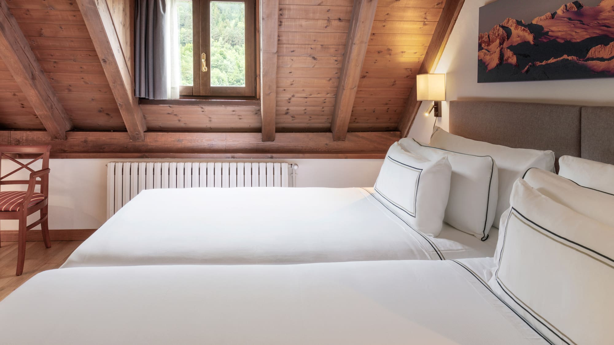 a room with two beds and a window