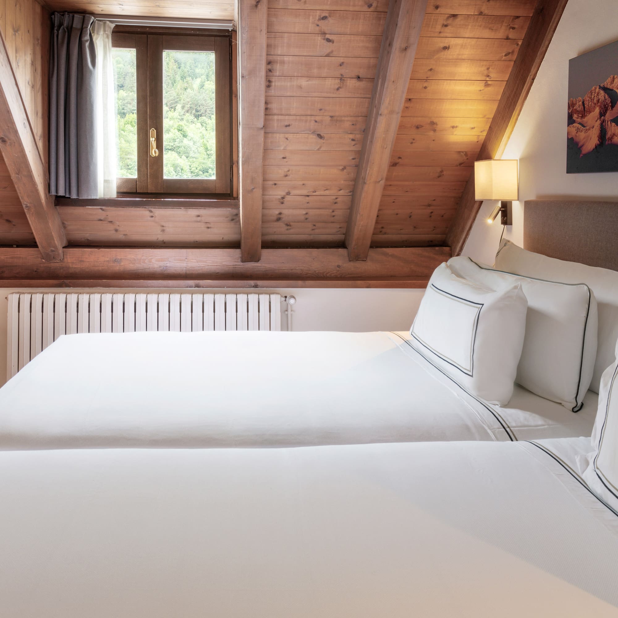 a room with two beds and a window