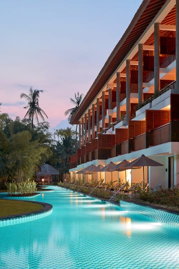 a pool with a building and trees