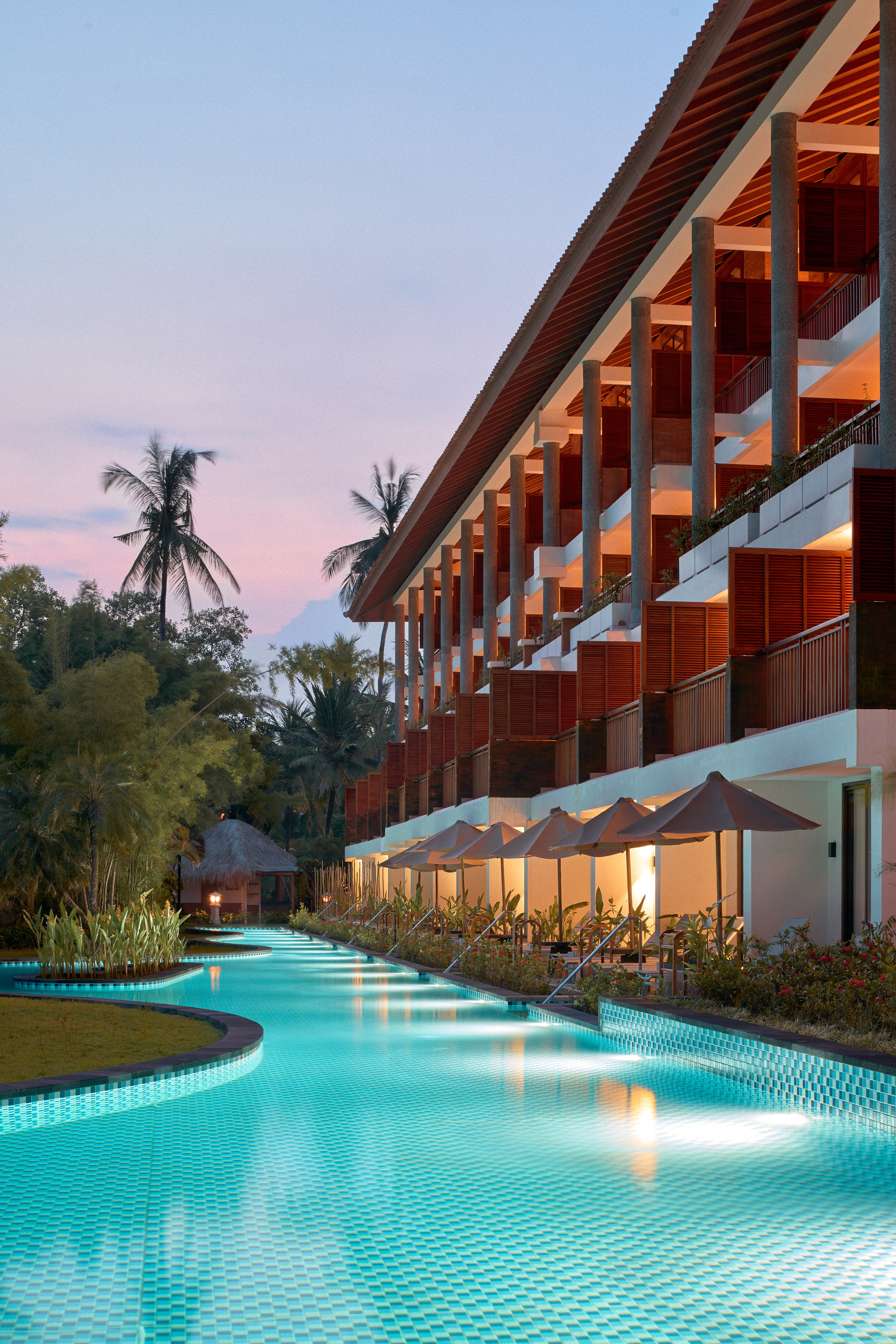 a pool with a building and trees