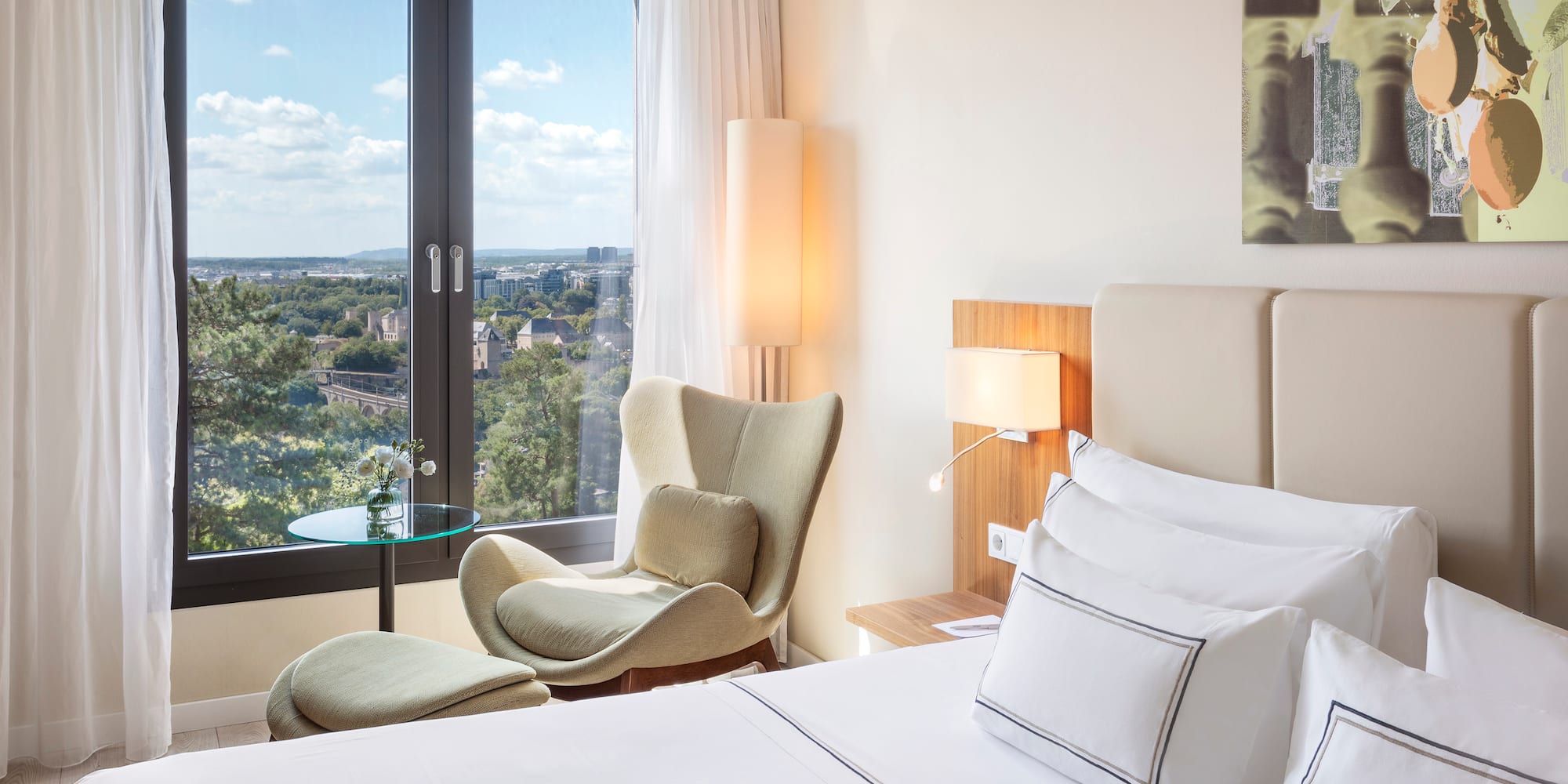 a bedroom with a bed and chairs and a table