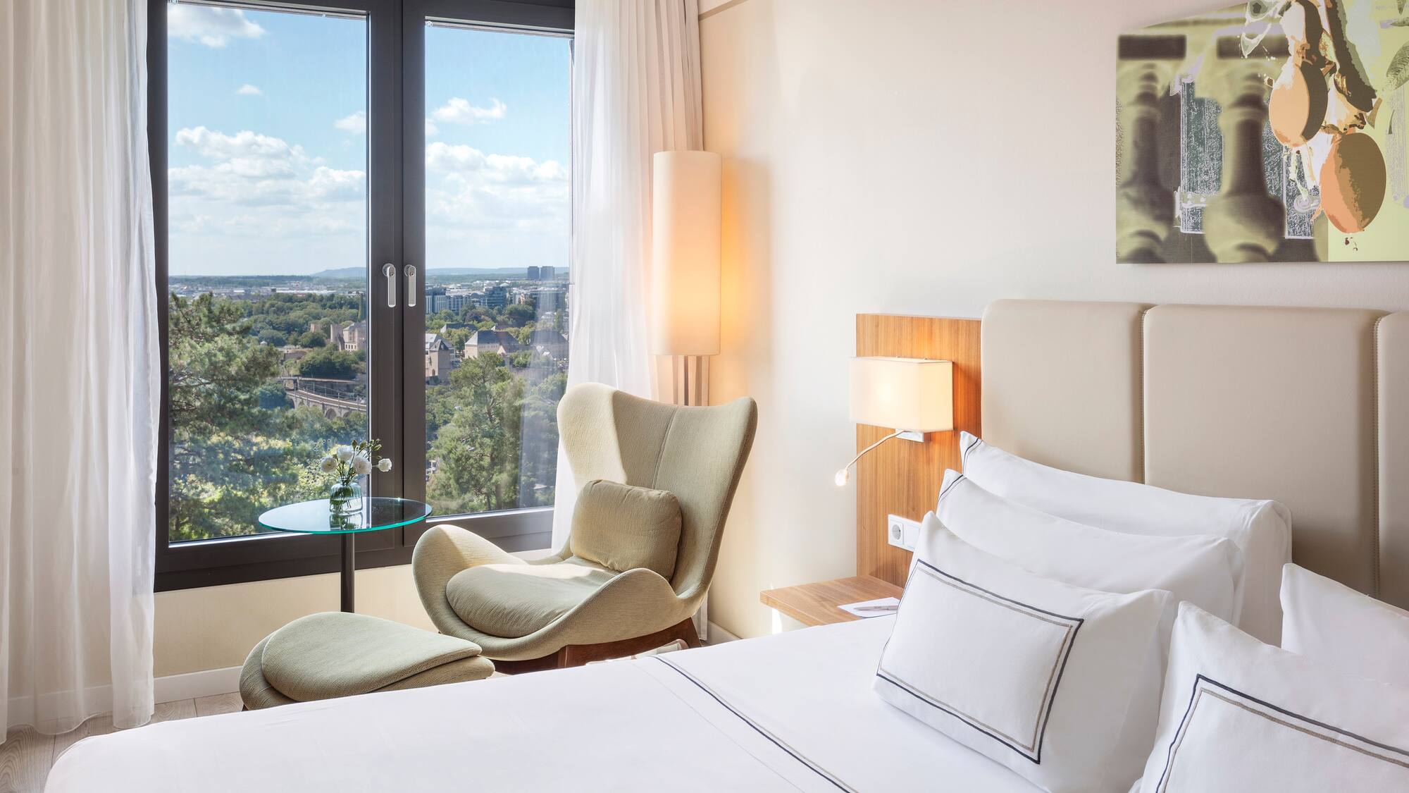 a bedroom with a bed and chairs and a table