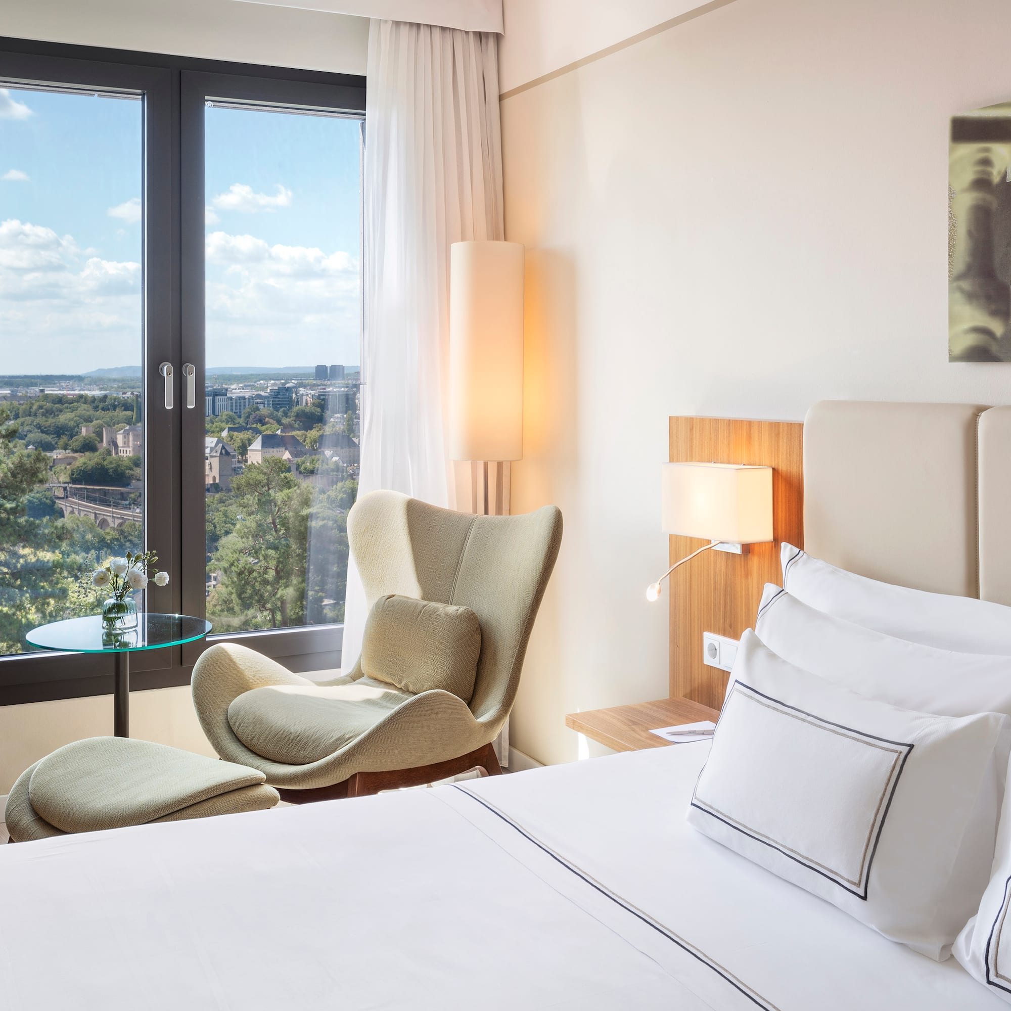 a bedroom with a bed and chairs and a table