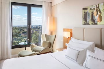 a bedroom with a bed and chairs and a table