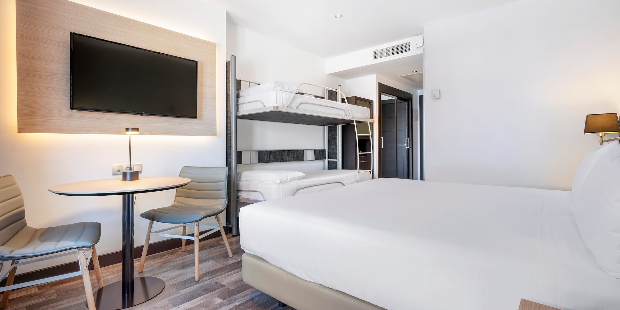 a room with bunk beds and a tv