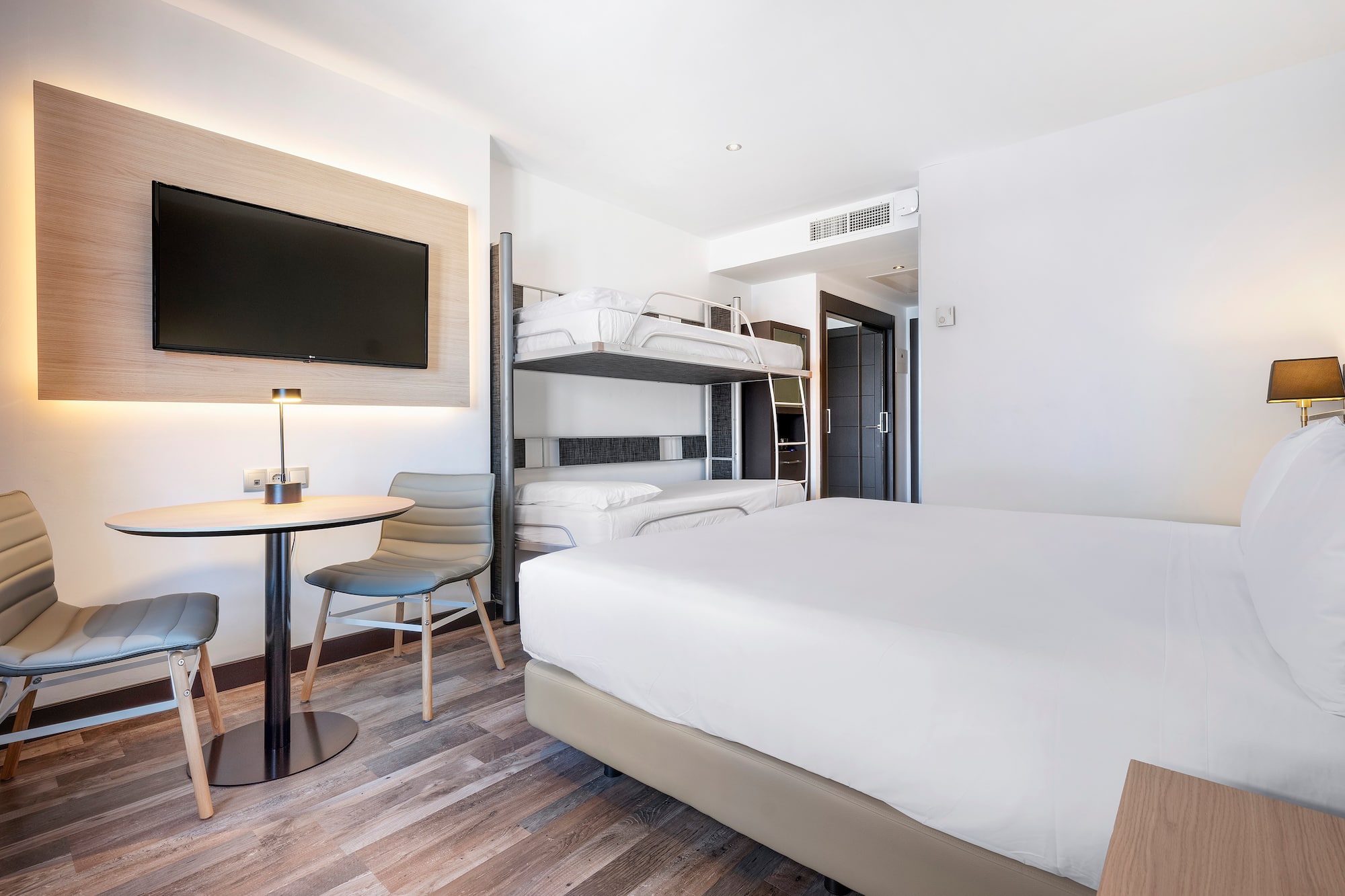 a room with bunk beds and a tv