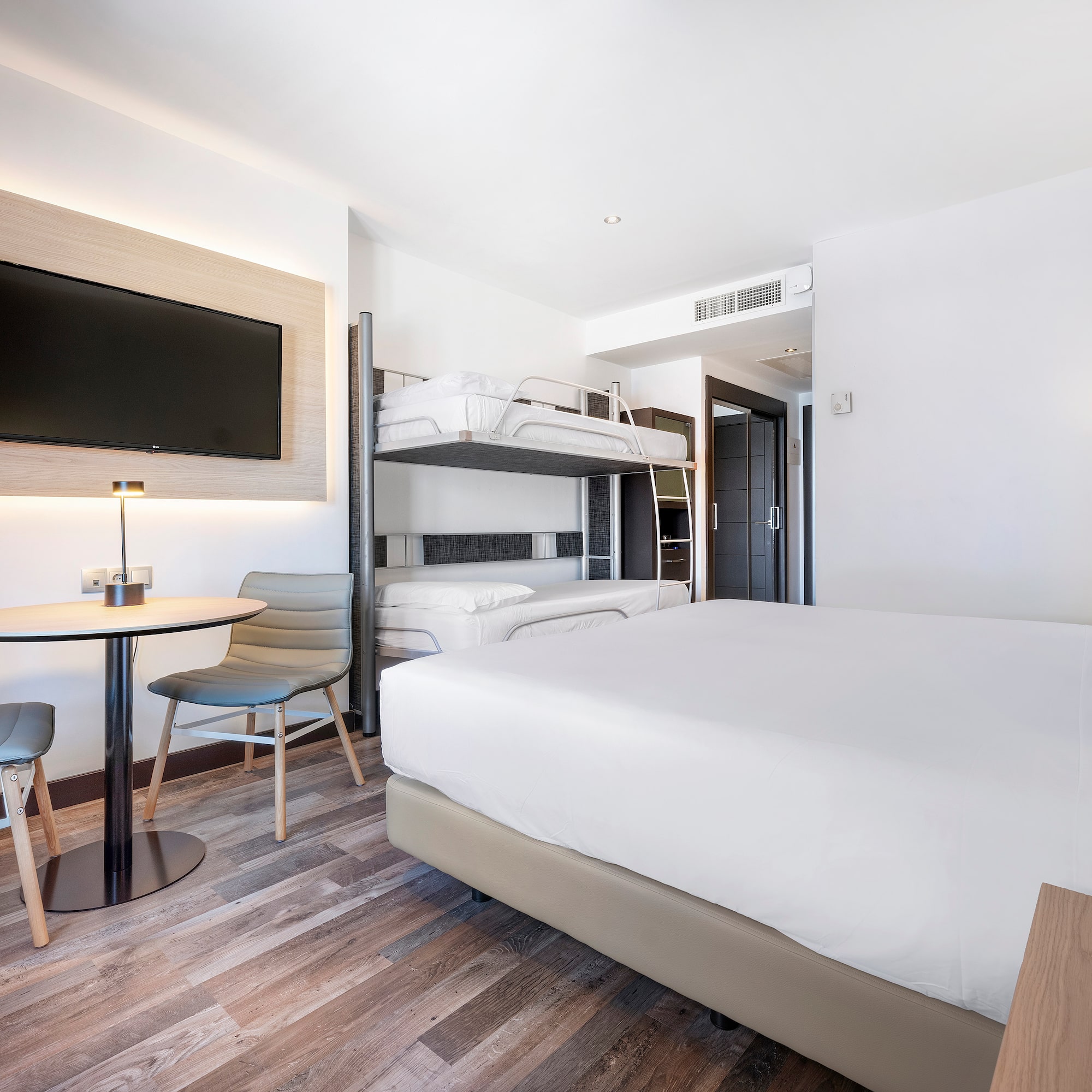 a room with bunk beds and a tv