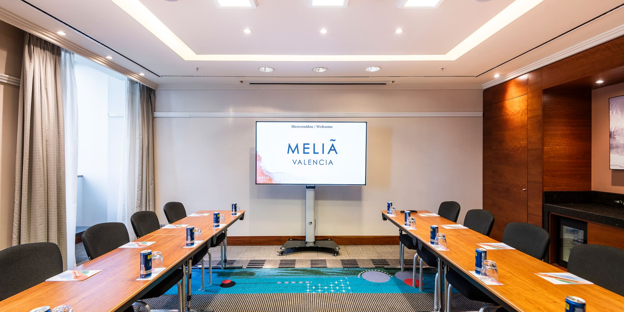 a room with long tables and chairs