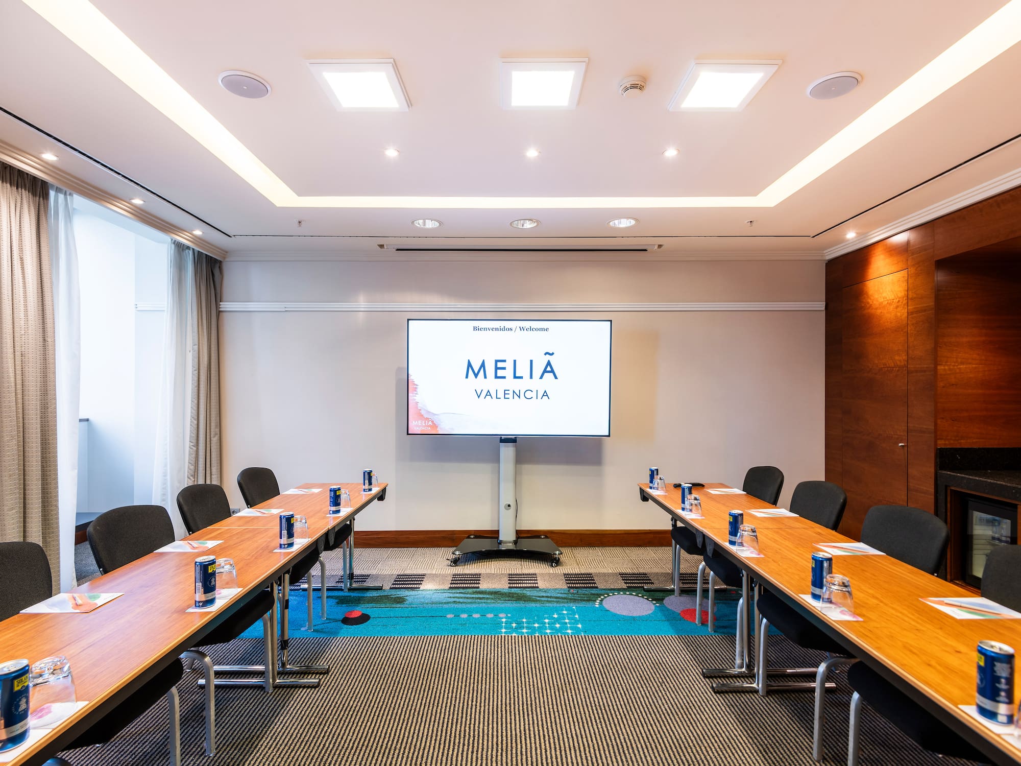a room with long tables and chairs