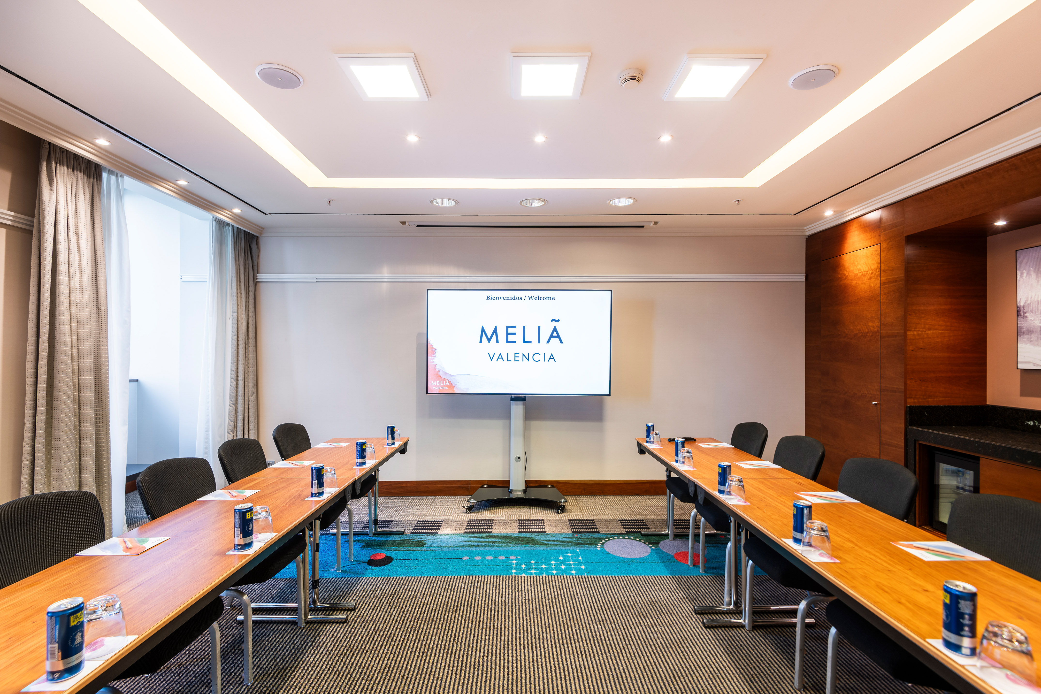 a room with long tables and chairs
