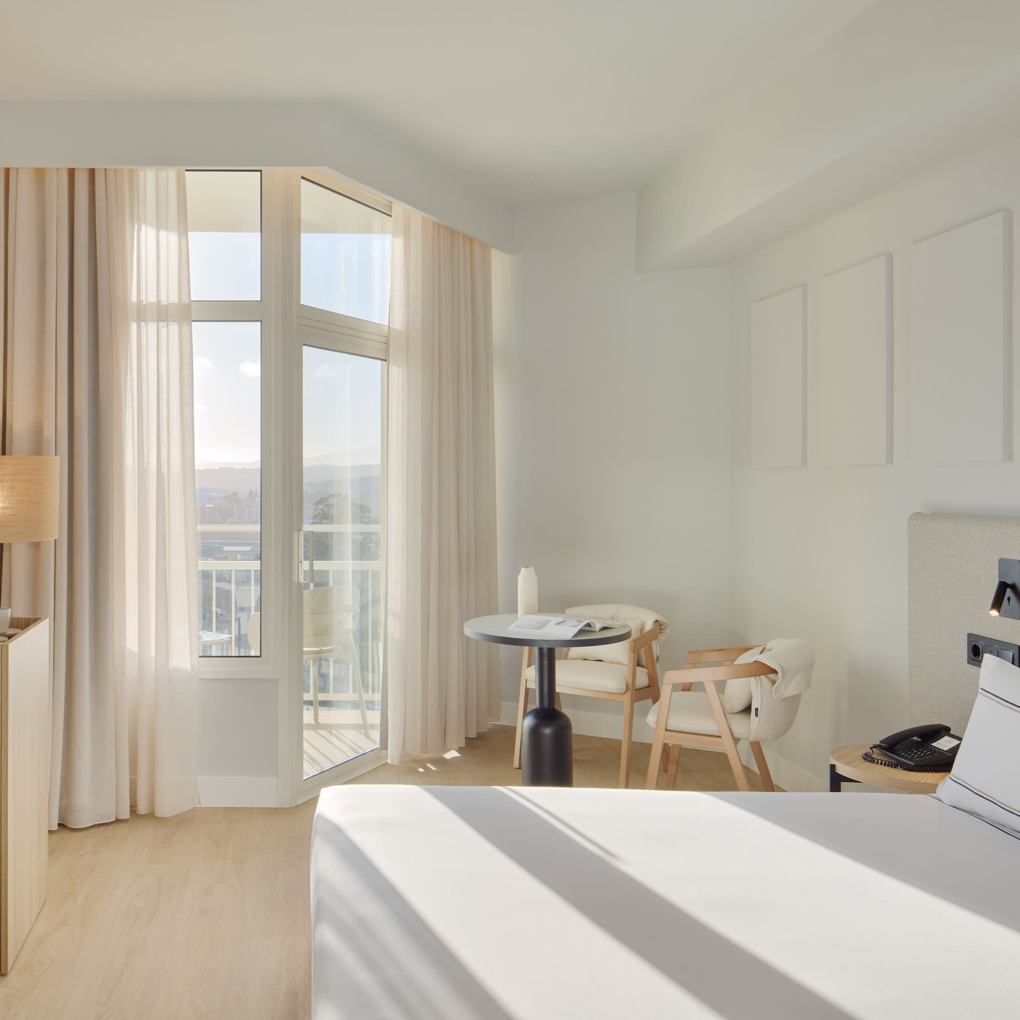 a room with a bed and a table and chairs