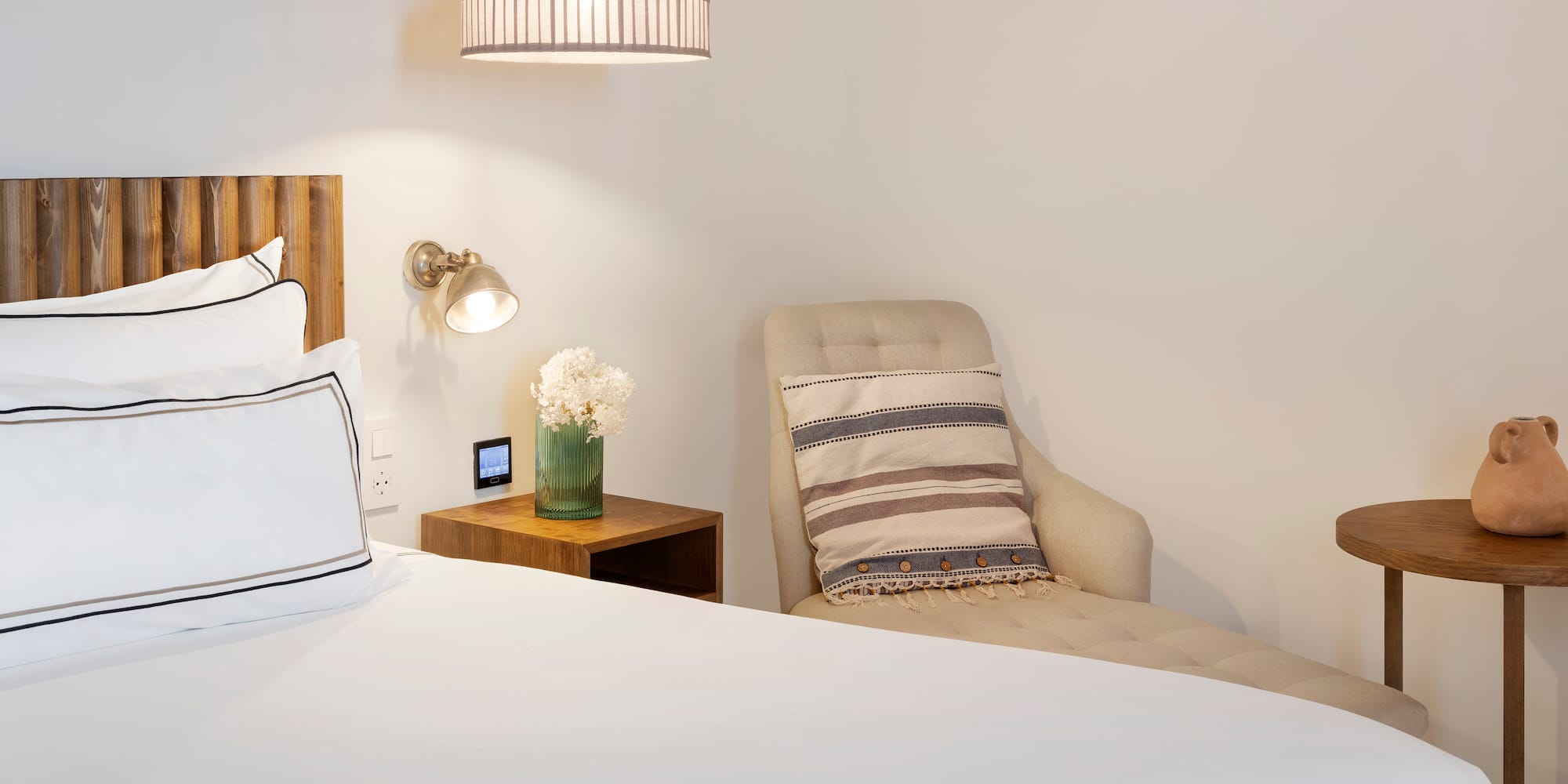 a bed with a chair and a lamp