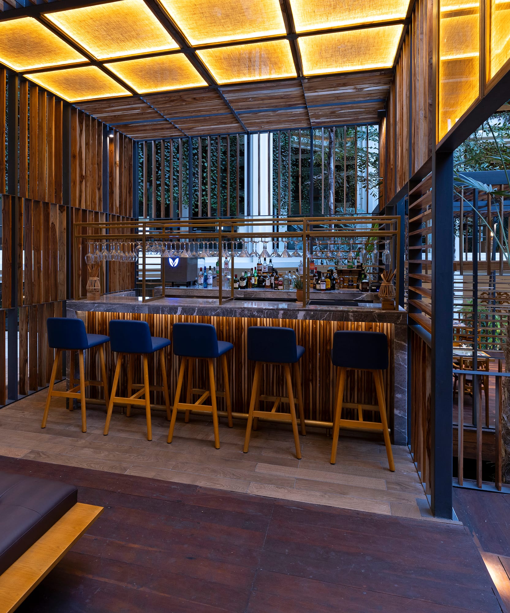 a bar with stools and a bench