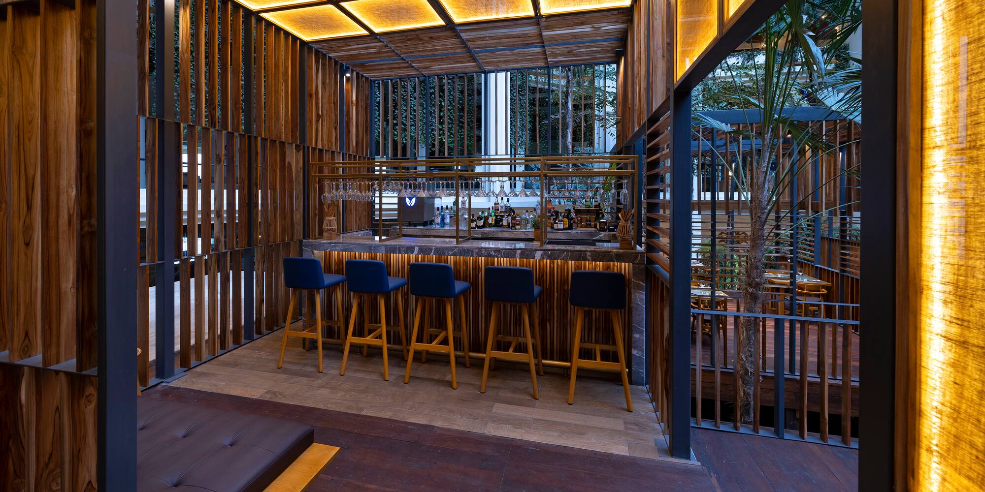 a bar with stools and a bench