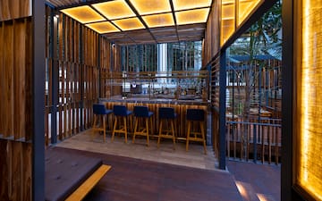 a bar with stools and a bench