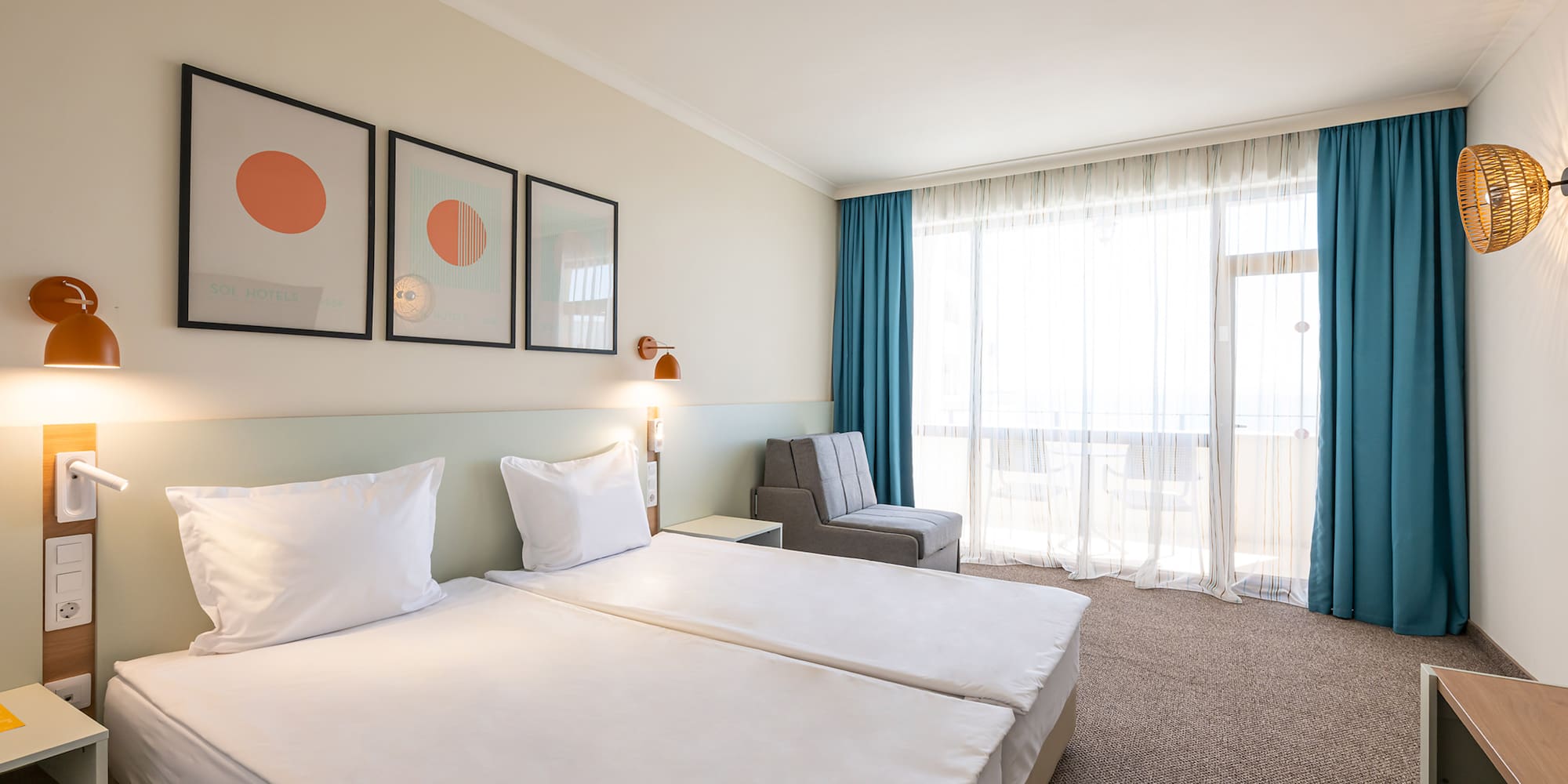 Bright modern hotel room with twin beds, stylish decor, blue curtains, and balcony.