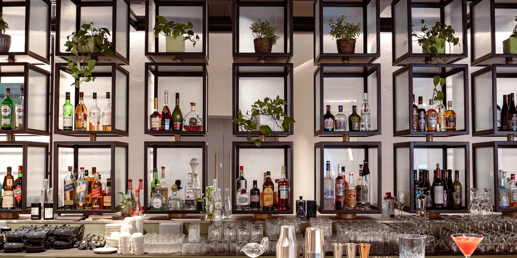 a bar with shelves of liquor and glasses