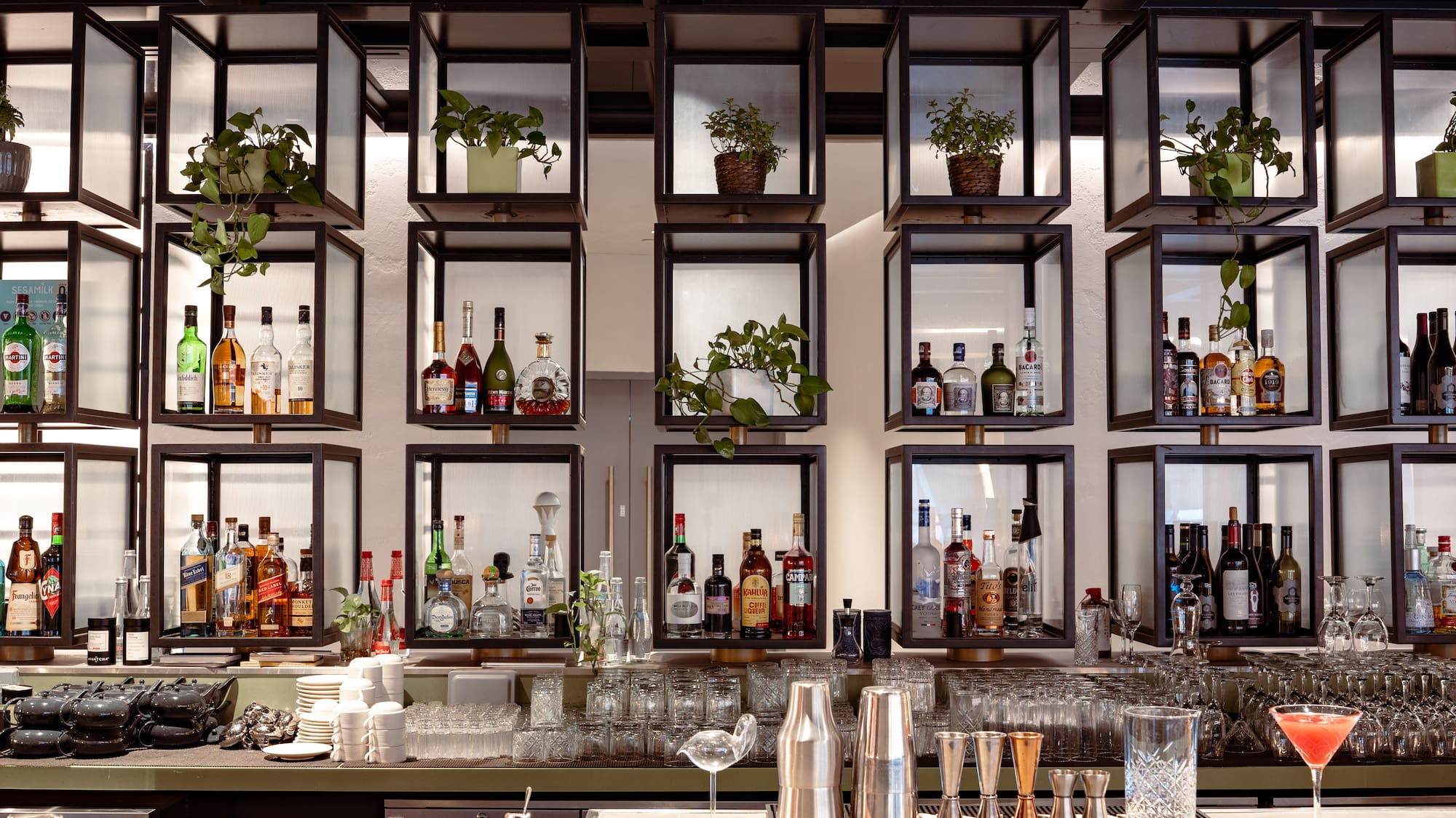 a bar with shelves of liquor and glasses