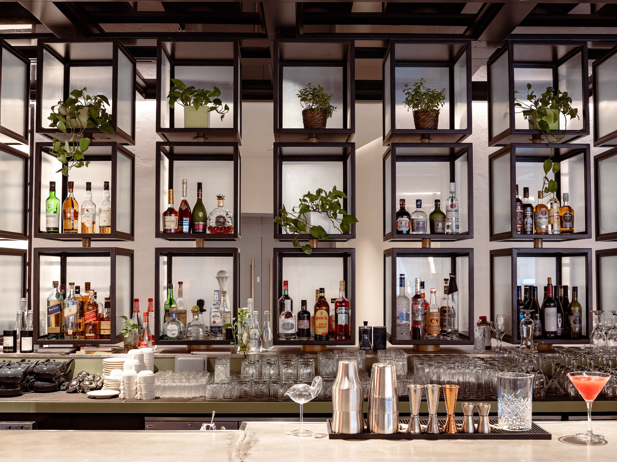 a bar with shelves of liquor and glasses