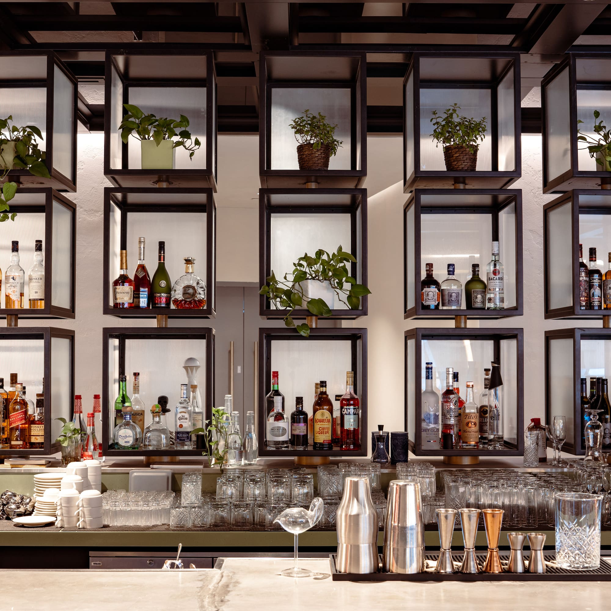 a bar with shelves of liquor and glasses